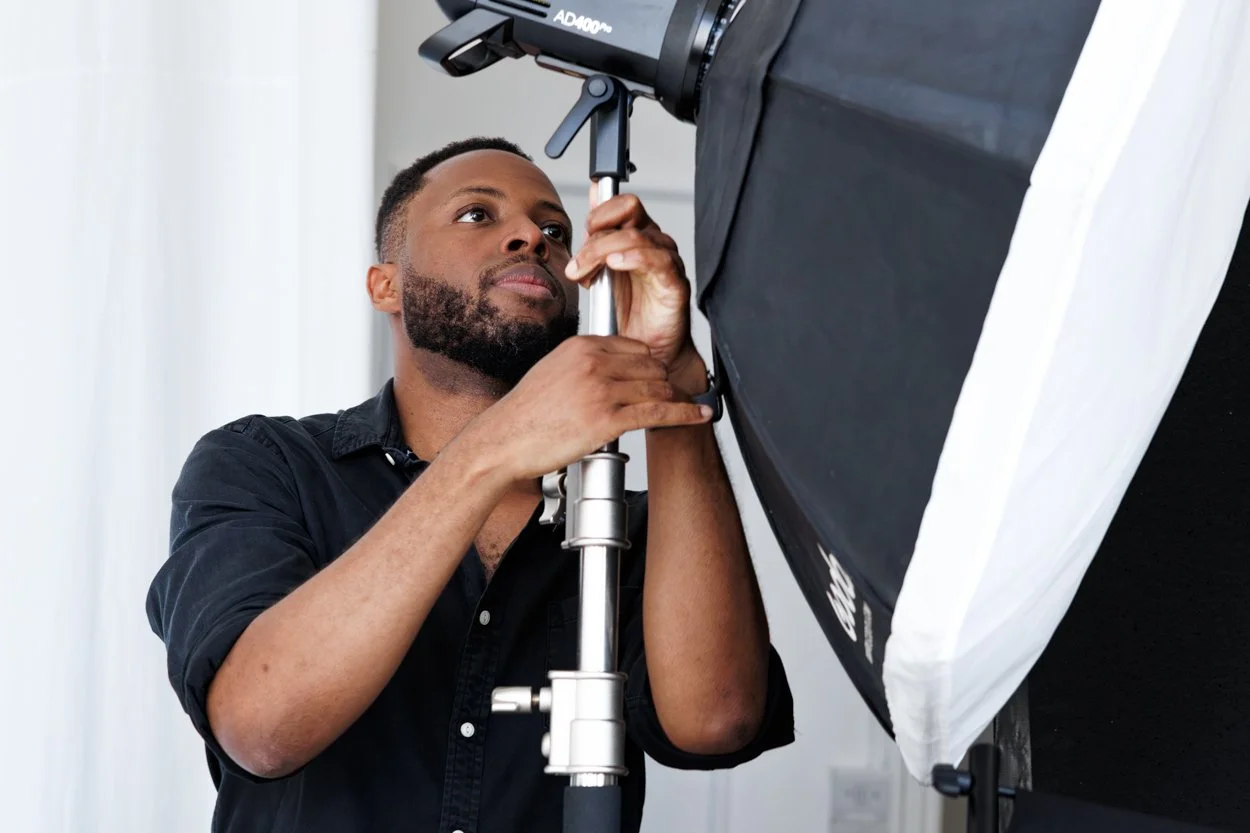 Corporate headshot photographer setting up a softbox light on location at a Marylebone law firm