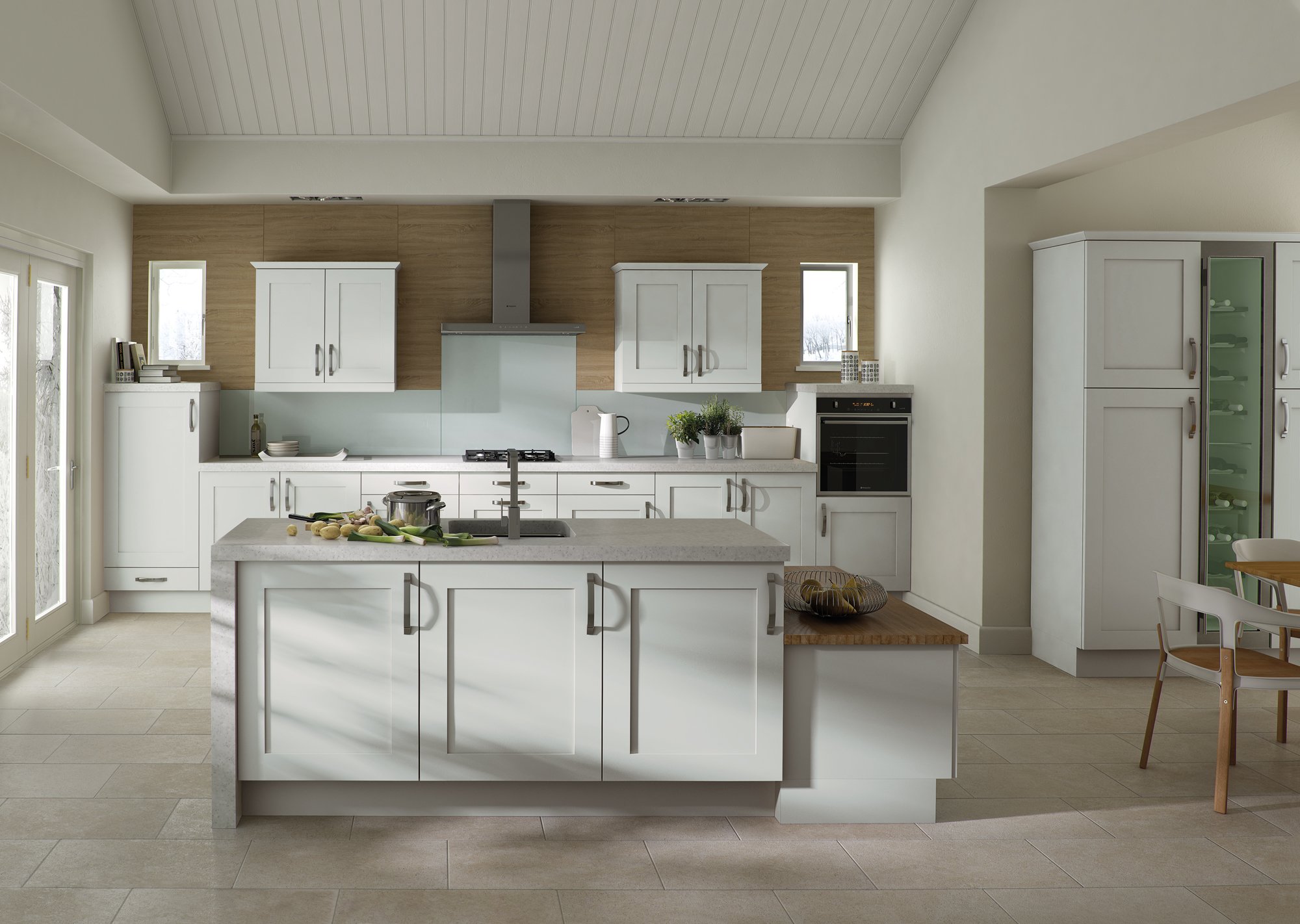 Modern kitchen interior with white cabinets, a central island with a sink, stovetop, and a pot. There's built-in ovens, decorative plants, and a glass-door wine cabinet. Natural light filters through large windows and the design features wood accents
