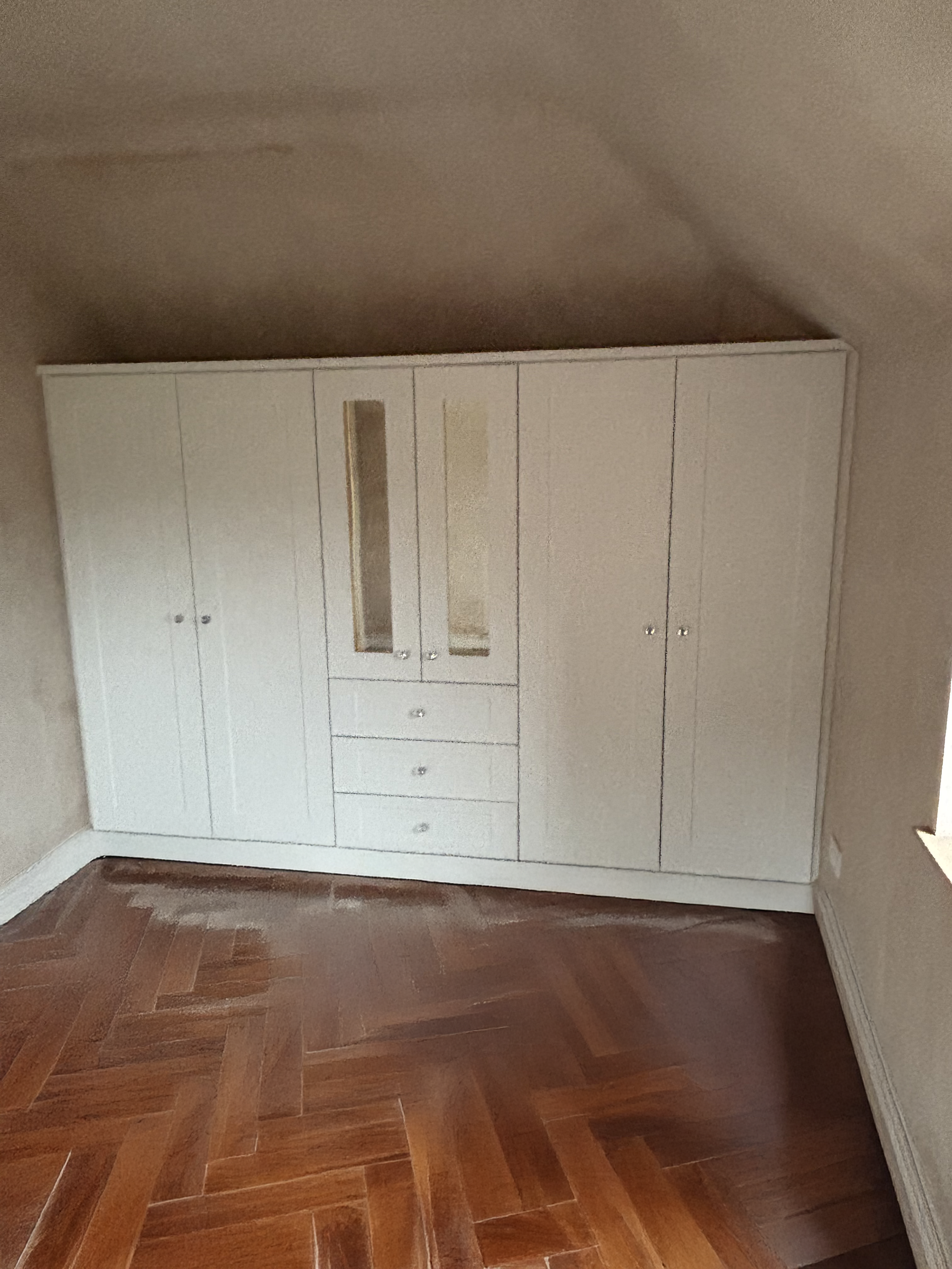 White built-in wardrobe with glass-paneled doors.