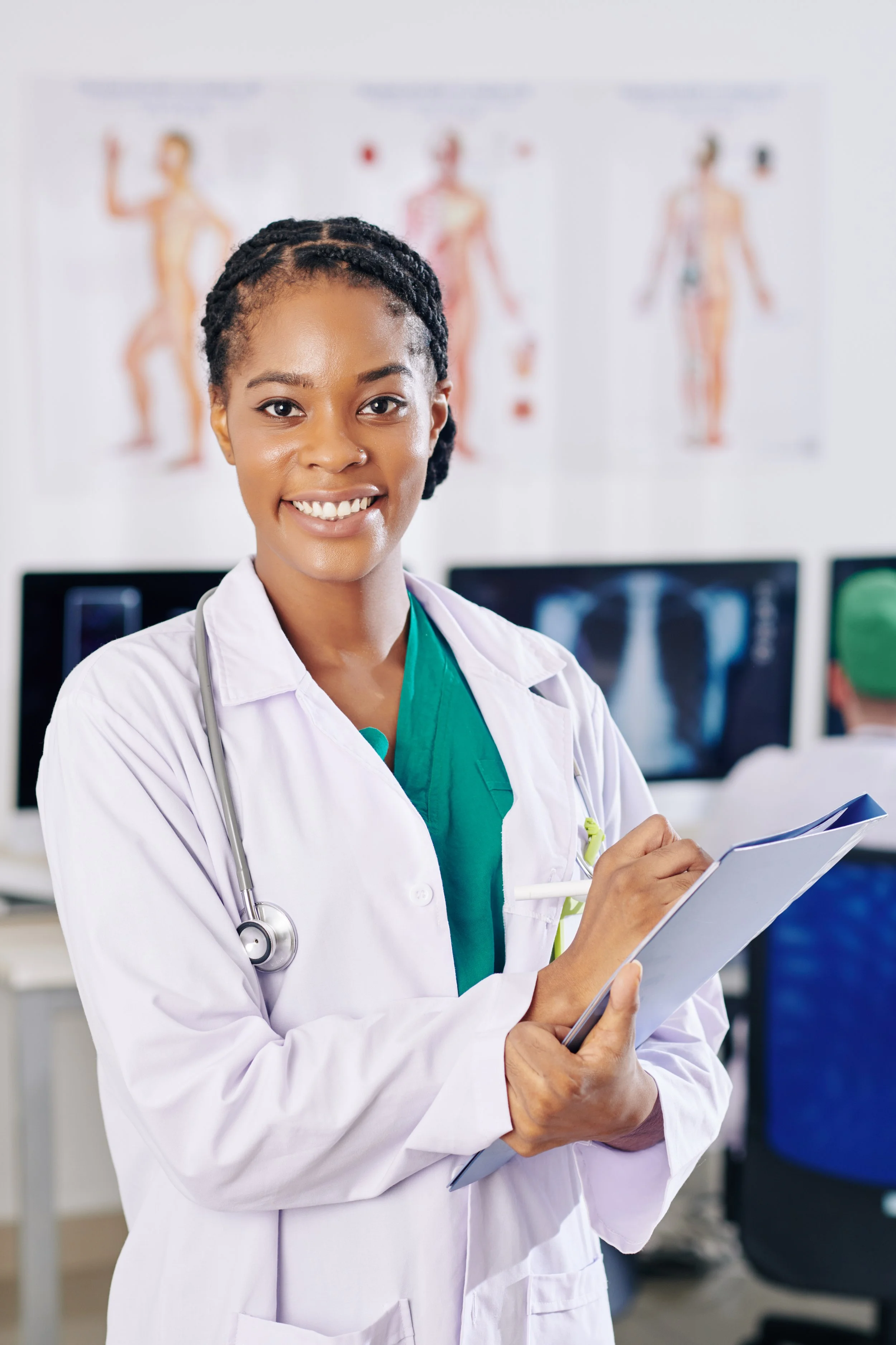 A Black doctor smiling and looking at the camera.