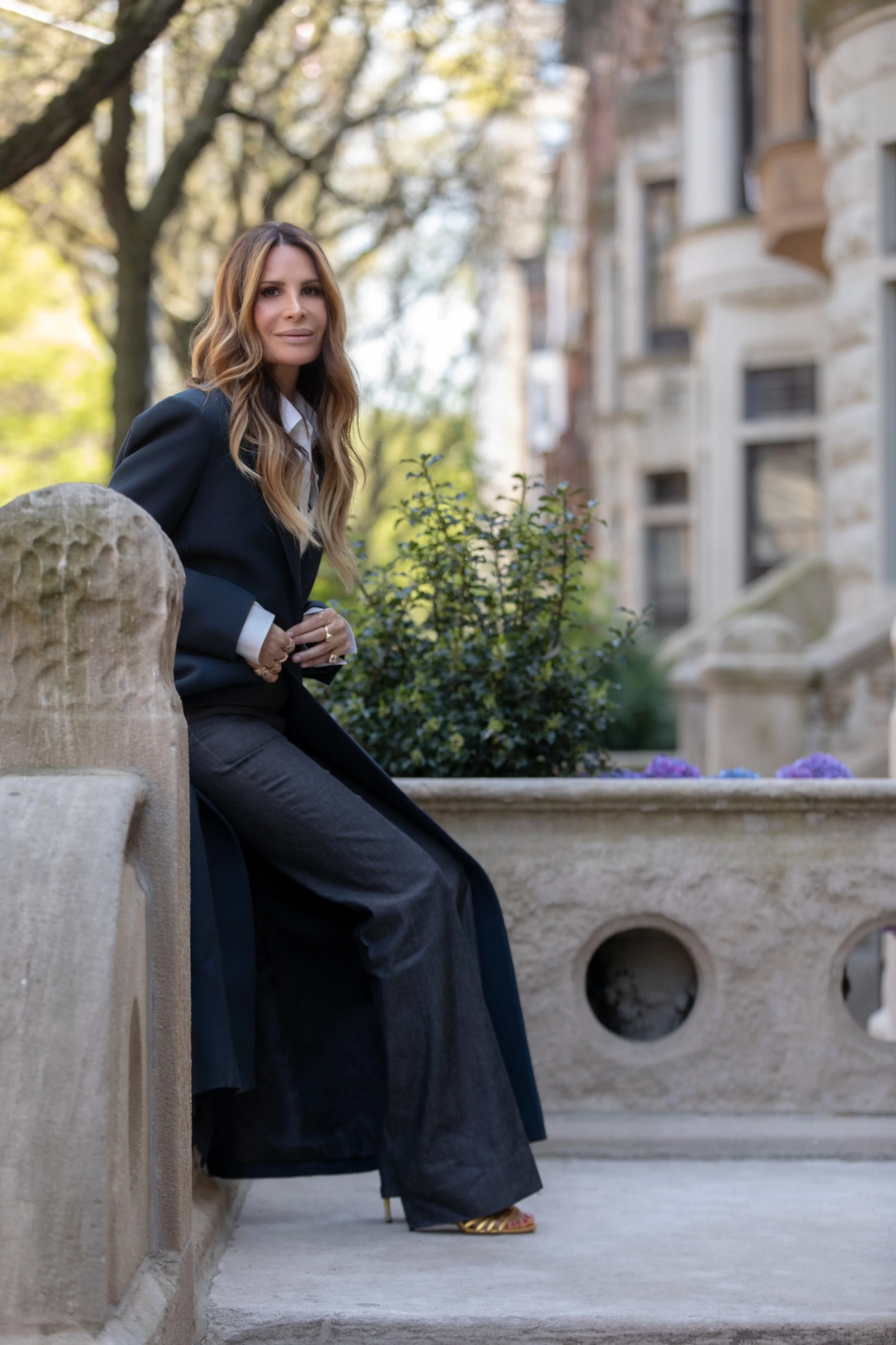 Gayle Perry seated on the entryway of an Upper East Side brownstone