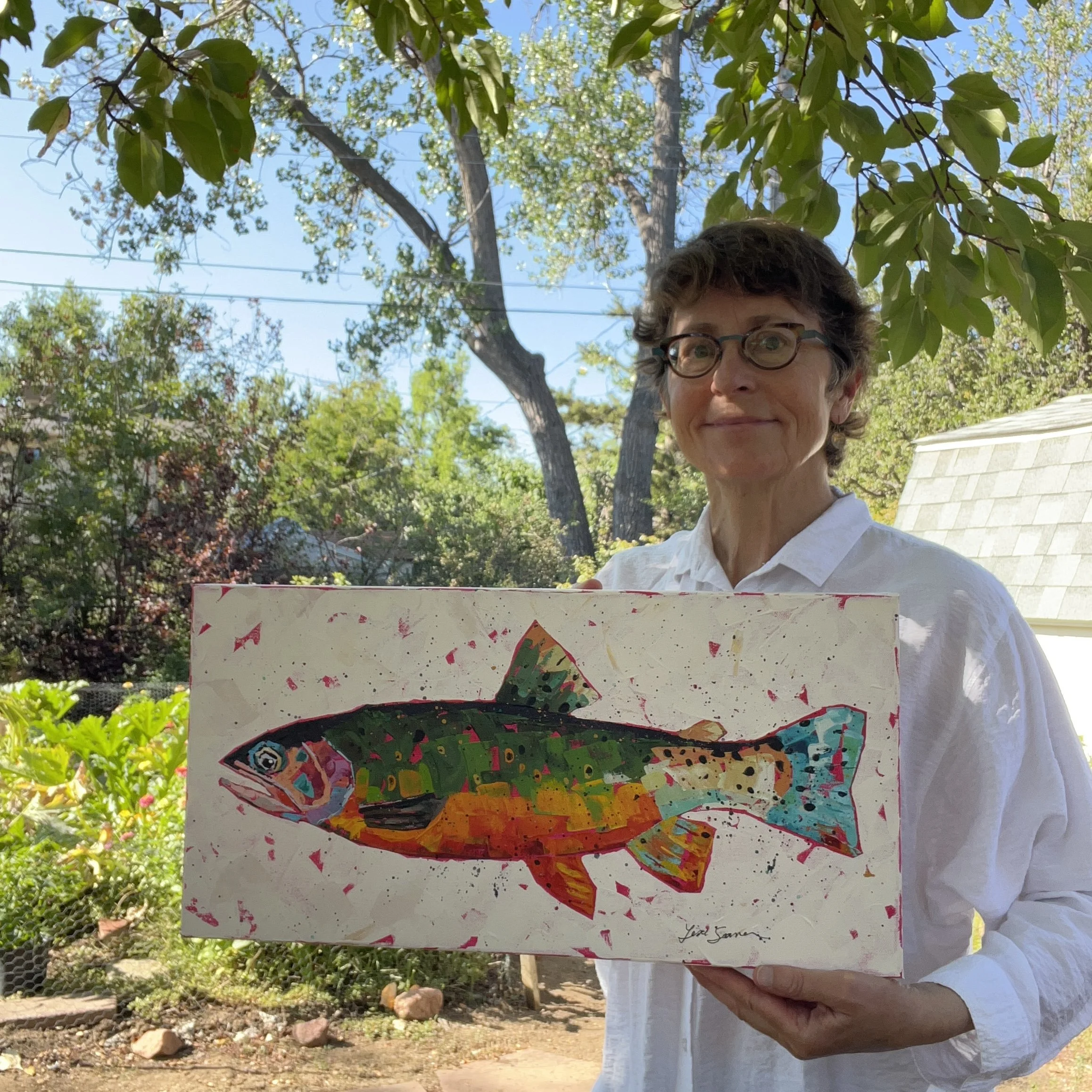 Lisa holding the trout painting