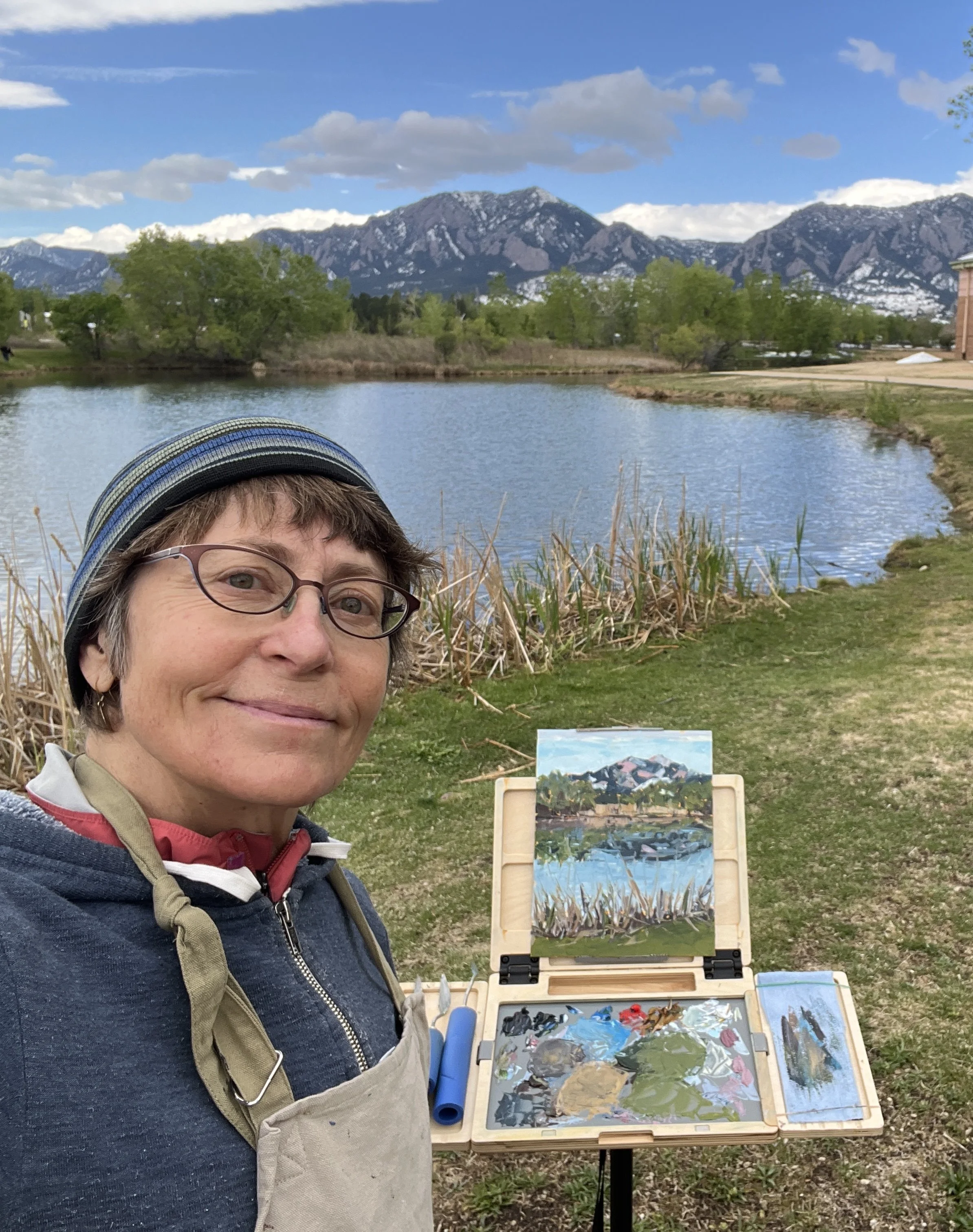 Lisa at her easel with lake in the background