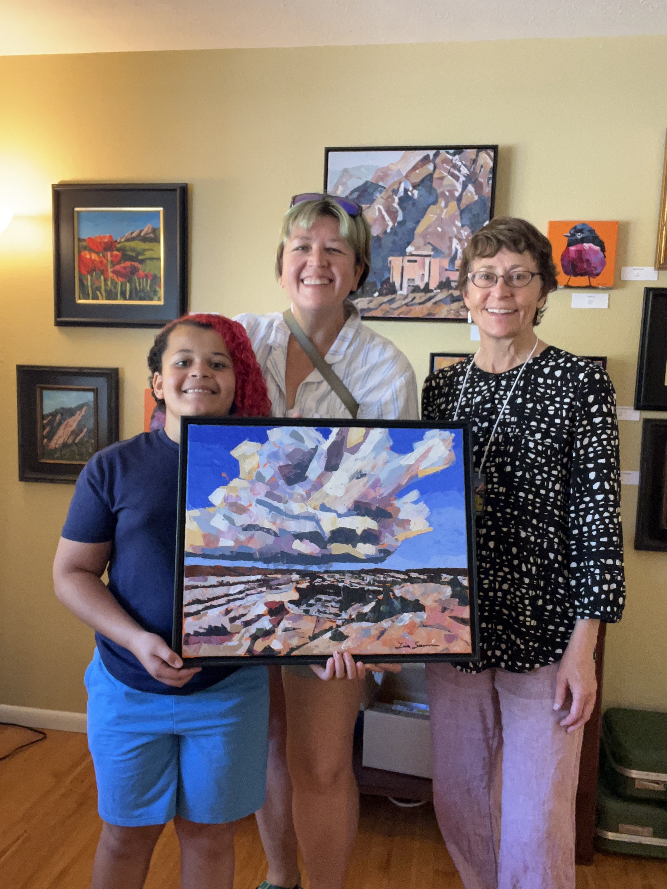 Standing with collectors and painting they bought
