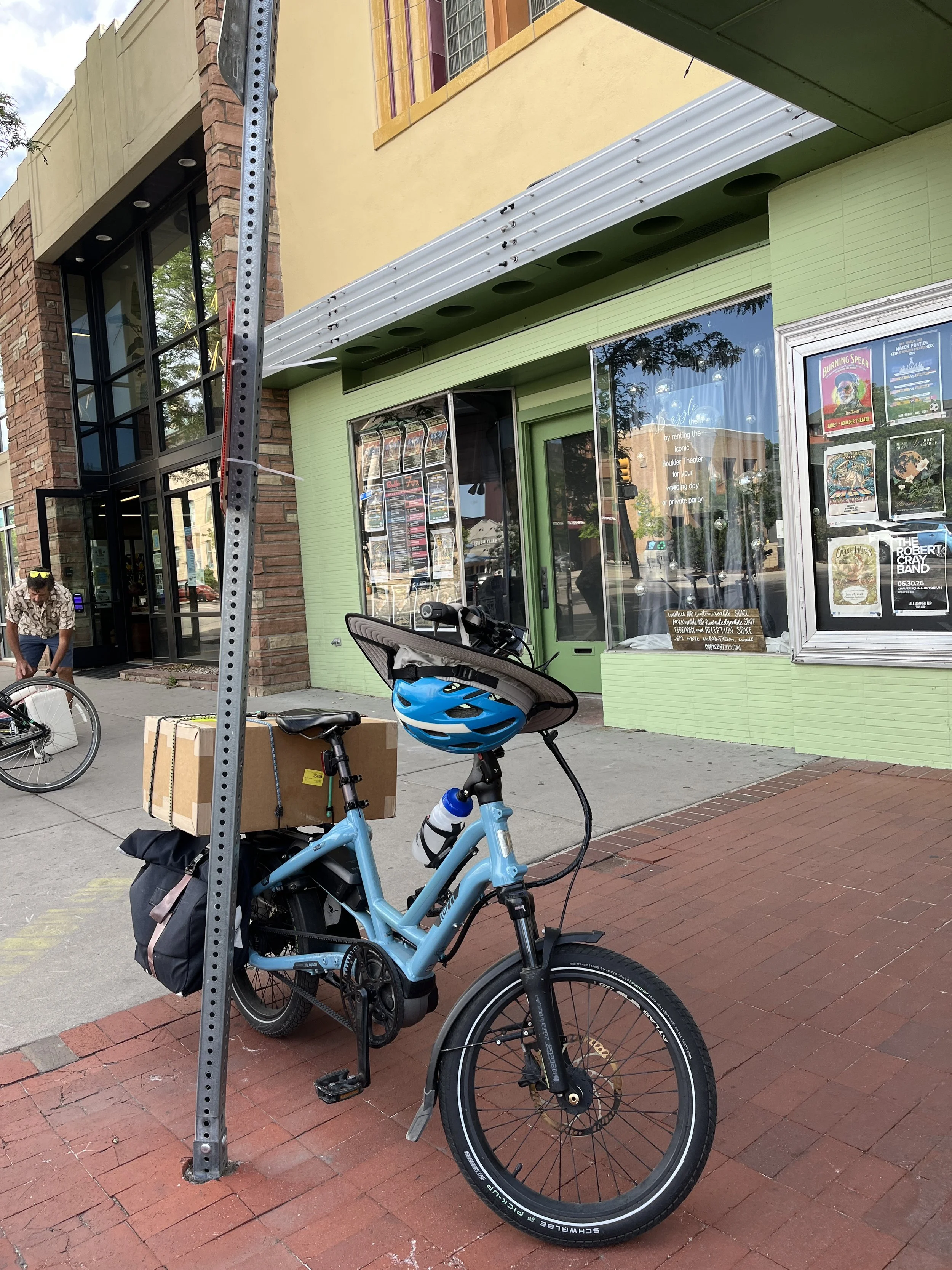 Lisa's bike parked at the exhibit with a box of paintings on the back.