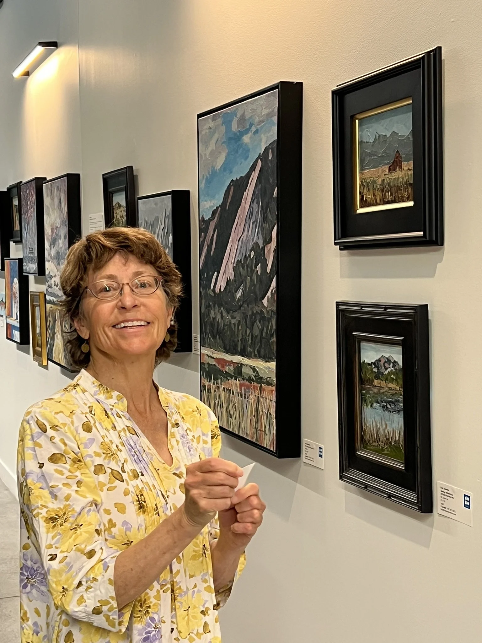 Lisa standing in front of paintings