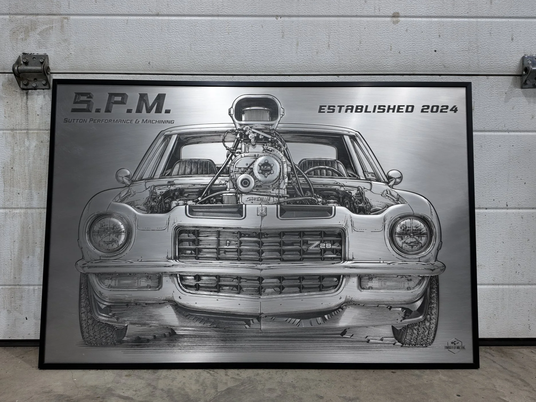 Illustration of a classic muscle car with a supercharger on top, detailed engine parts visible, framed in black, with the text 'S.P.M.' and 'Established 2024' at the top.