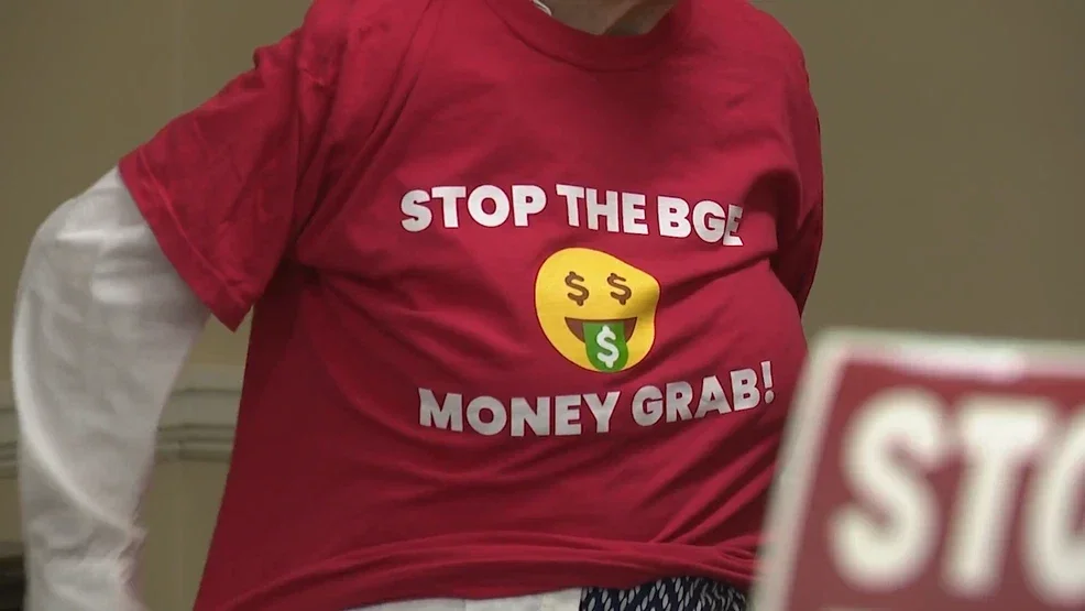 Woman in read shirt that reads "stop the BGE money grab!"