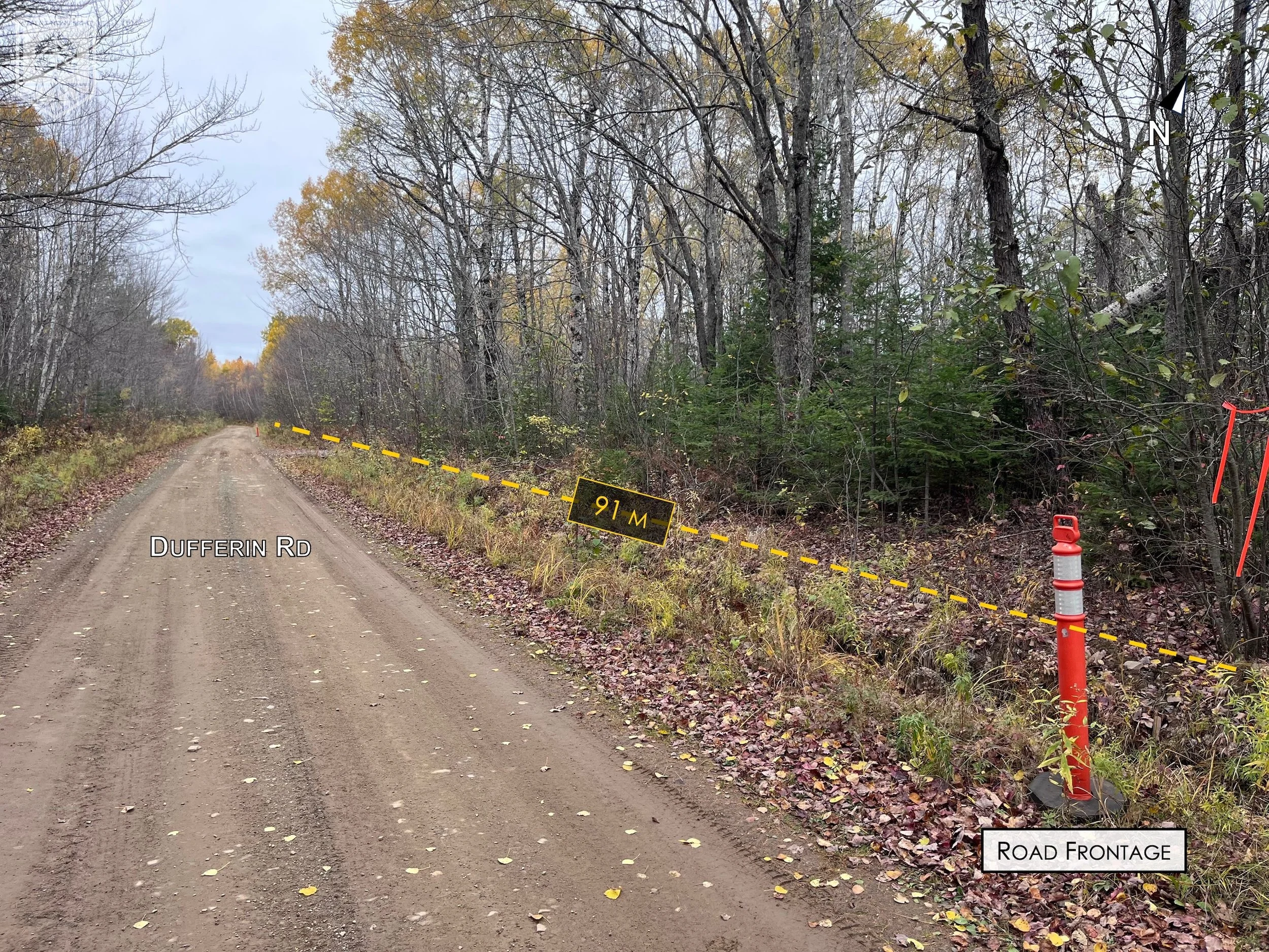 A dirt road labeled Dufferin Rd running through a wooded area with leafless trees on both sides. There is a yellow dashed line indicating a measurement of 91 meters on the right side of the road. An orange traffic barrel and a sign marking the road f