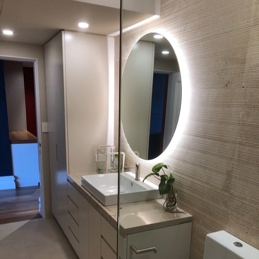 Modern Bathroom renovation, floating vanity, round mirror backlit