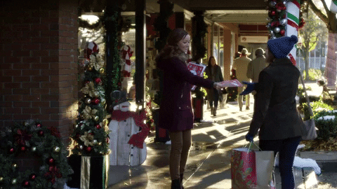 Hlamark Channel movie girl handing out Christmas flyers
