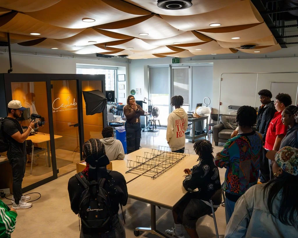 Teens visiting a creative studio and learning about its equipment