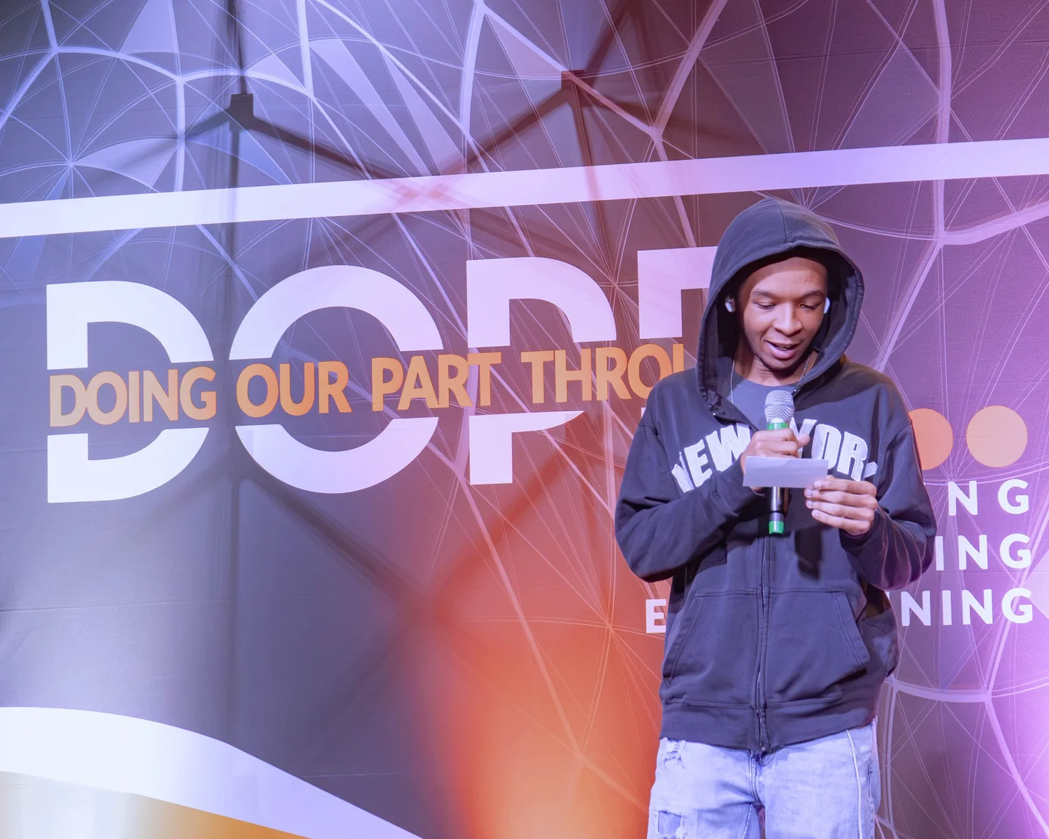 A teen speaking into a microphone at a DOPE event