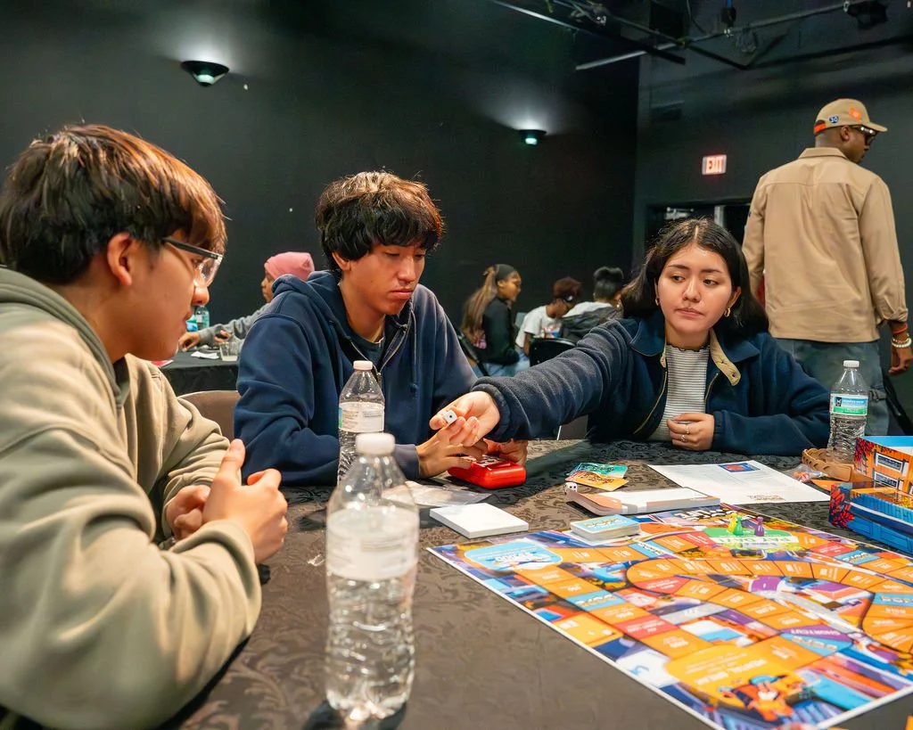 Teens playing Living a DOPE Life together around a table