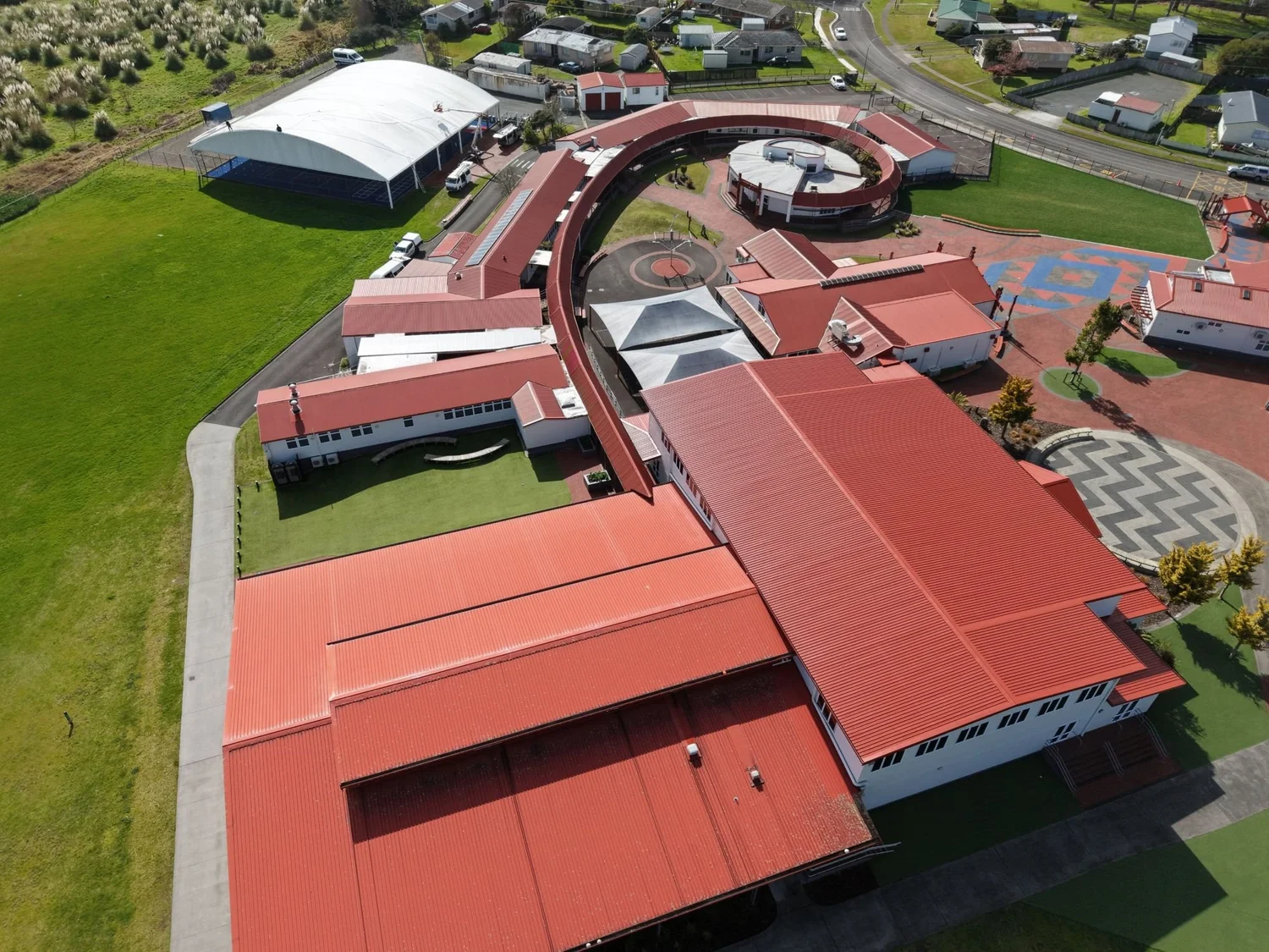 Aerial view of a school campus with treated roofs