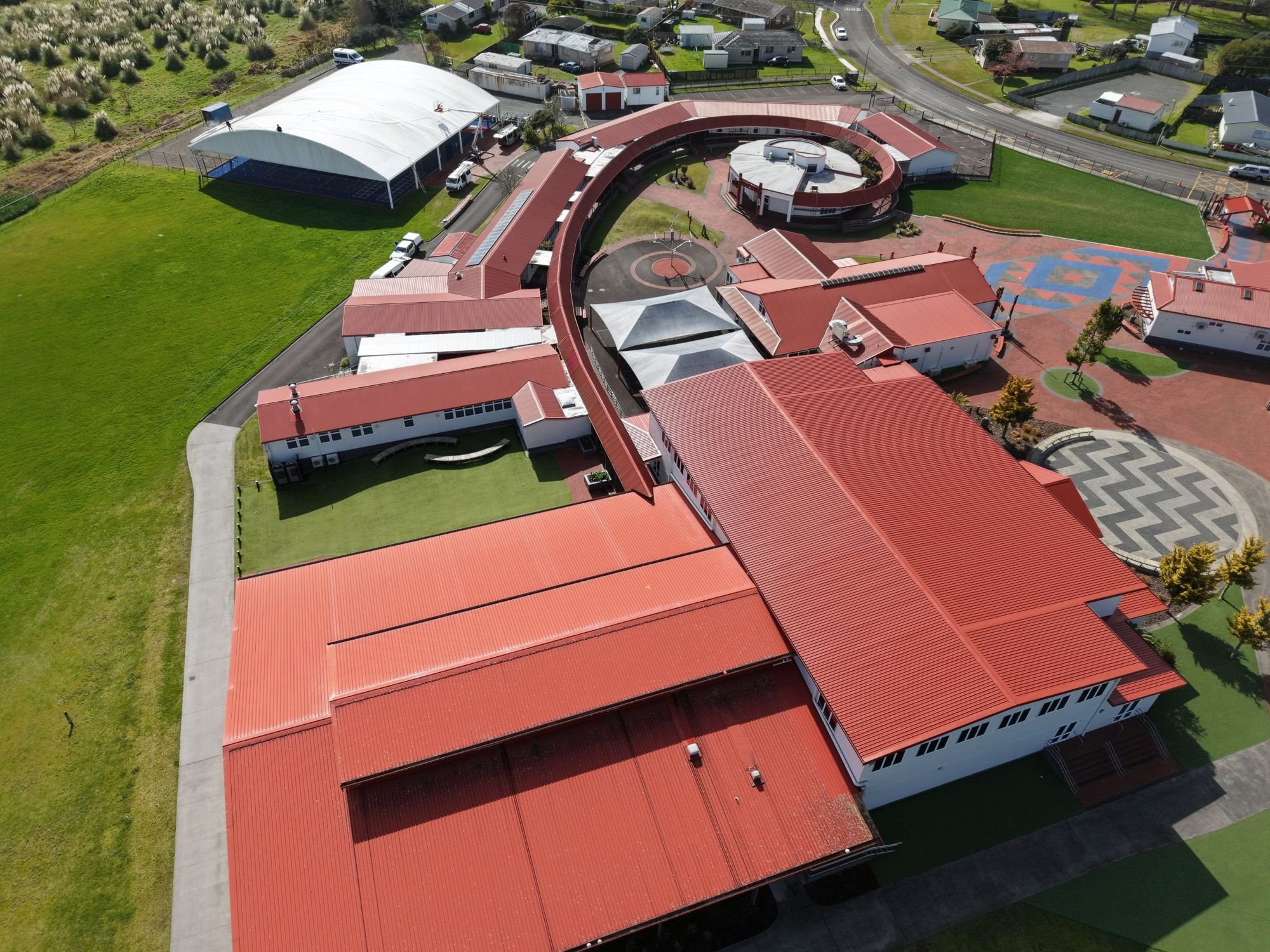 Aerial view of a school campus with drone-treated roofs