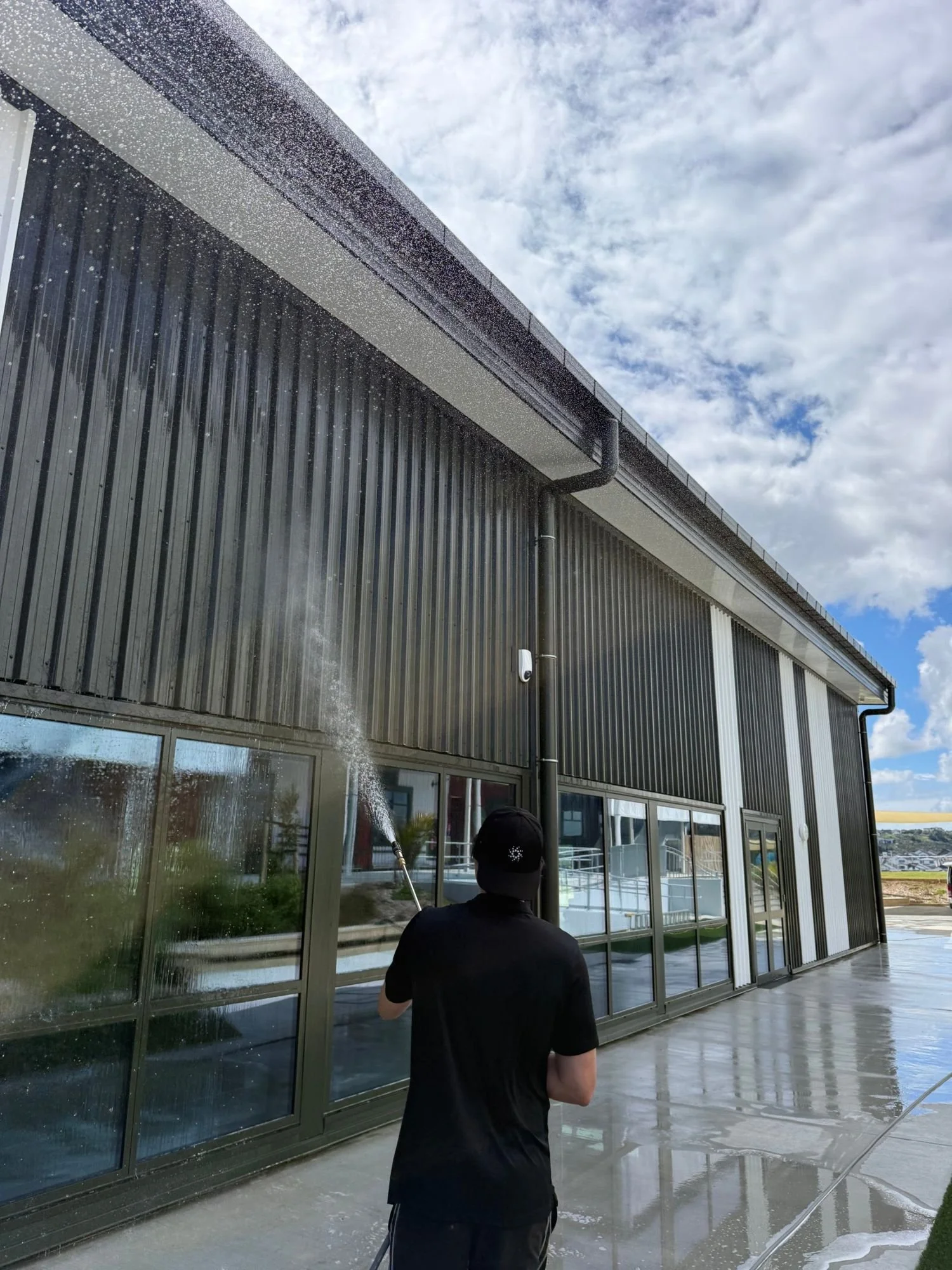 AeroSpray technician washing a commercial building