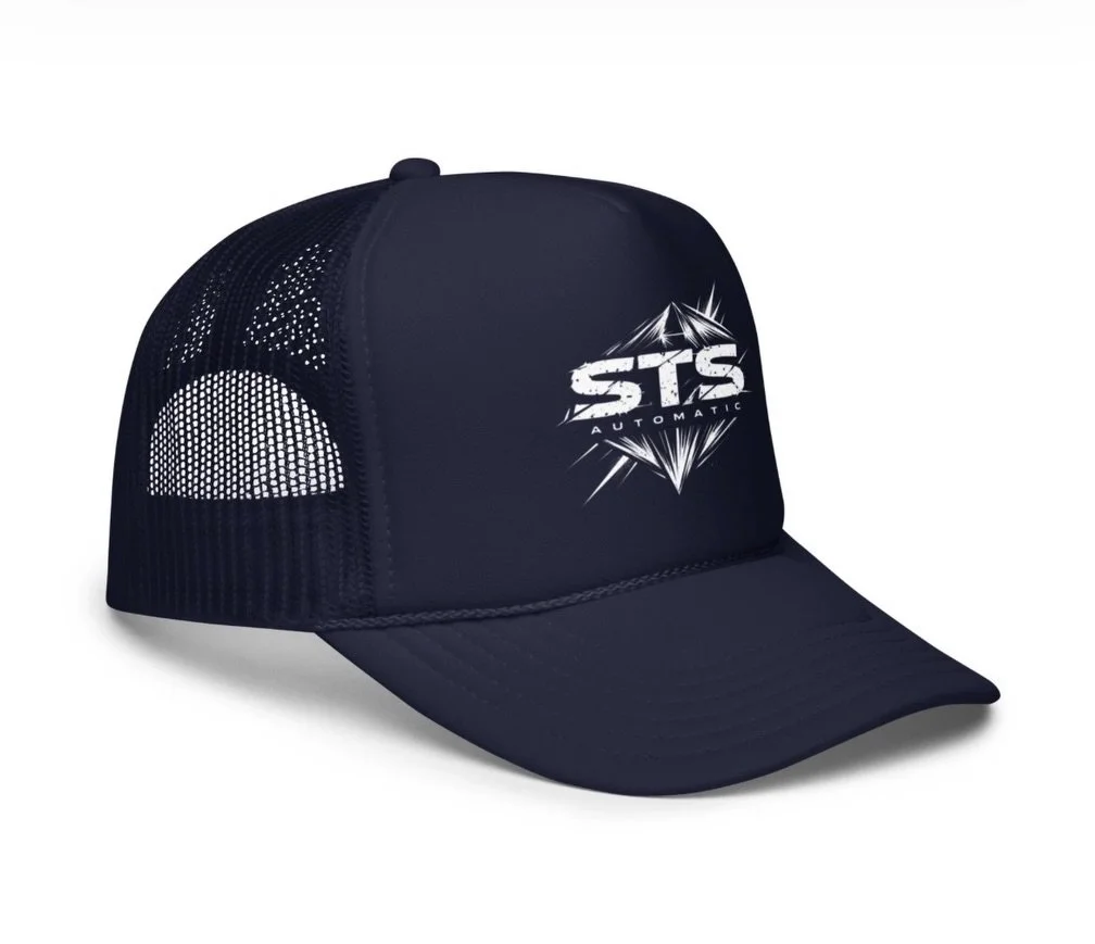 We&rsquo;ve been focused on building &mdash;
software, tools, systems that actually move things forward.

This hat came from that same mindset.

The Cosmic STS Trucker Hat
A prismatic take on something simple for the summer.

Built for wherever you&r