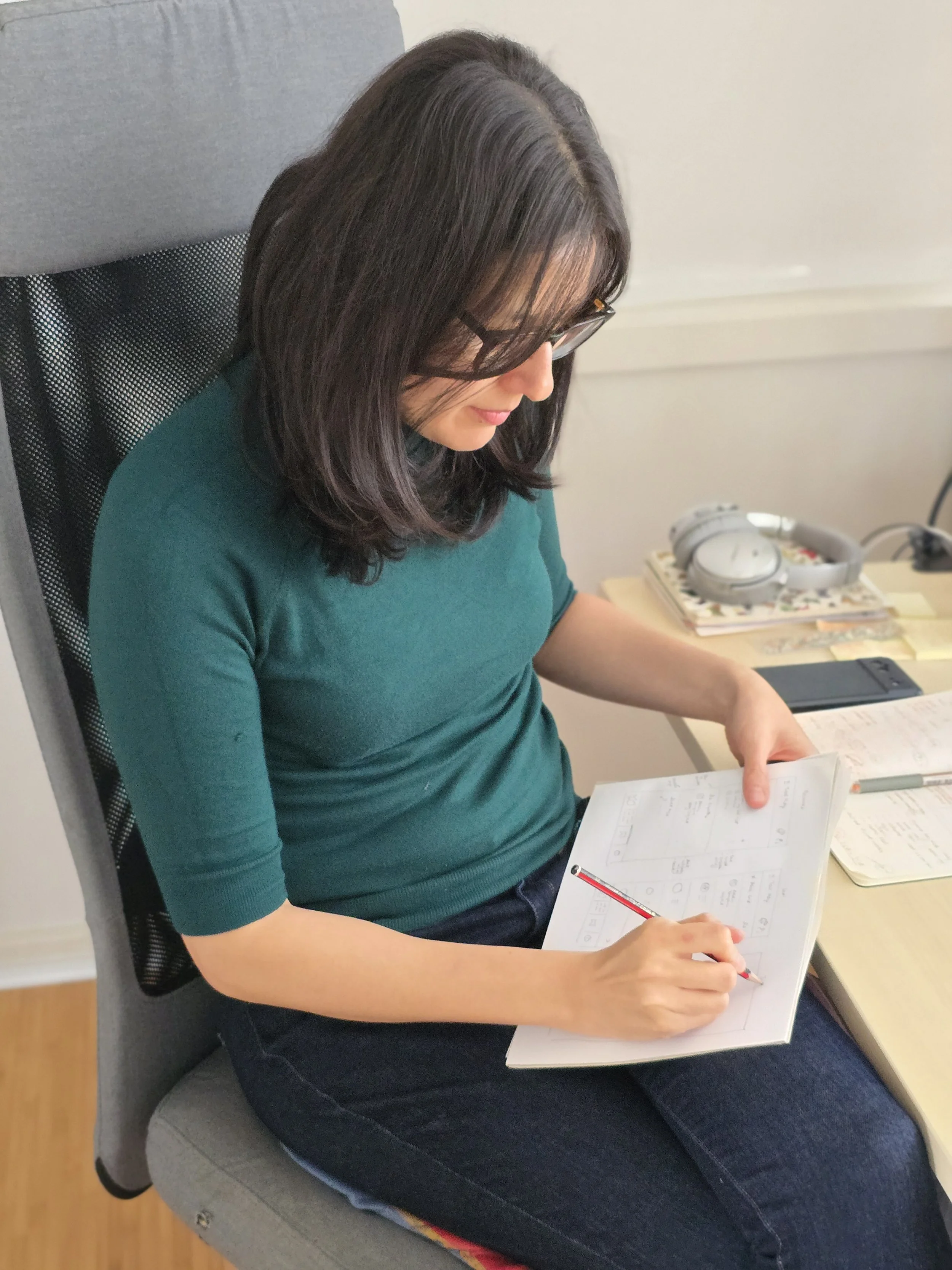 Consultant sketching solutions on paper at a desk