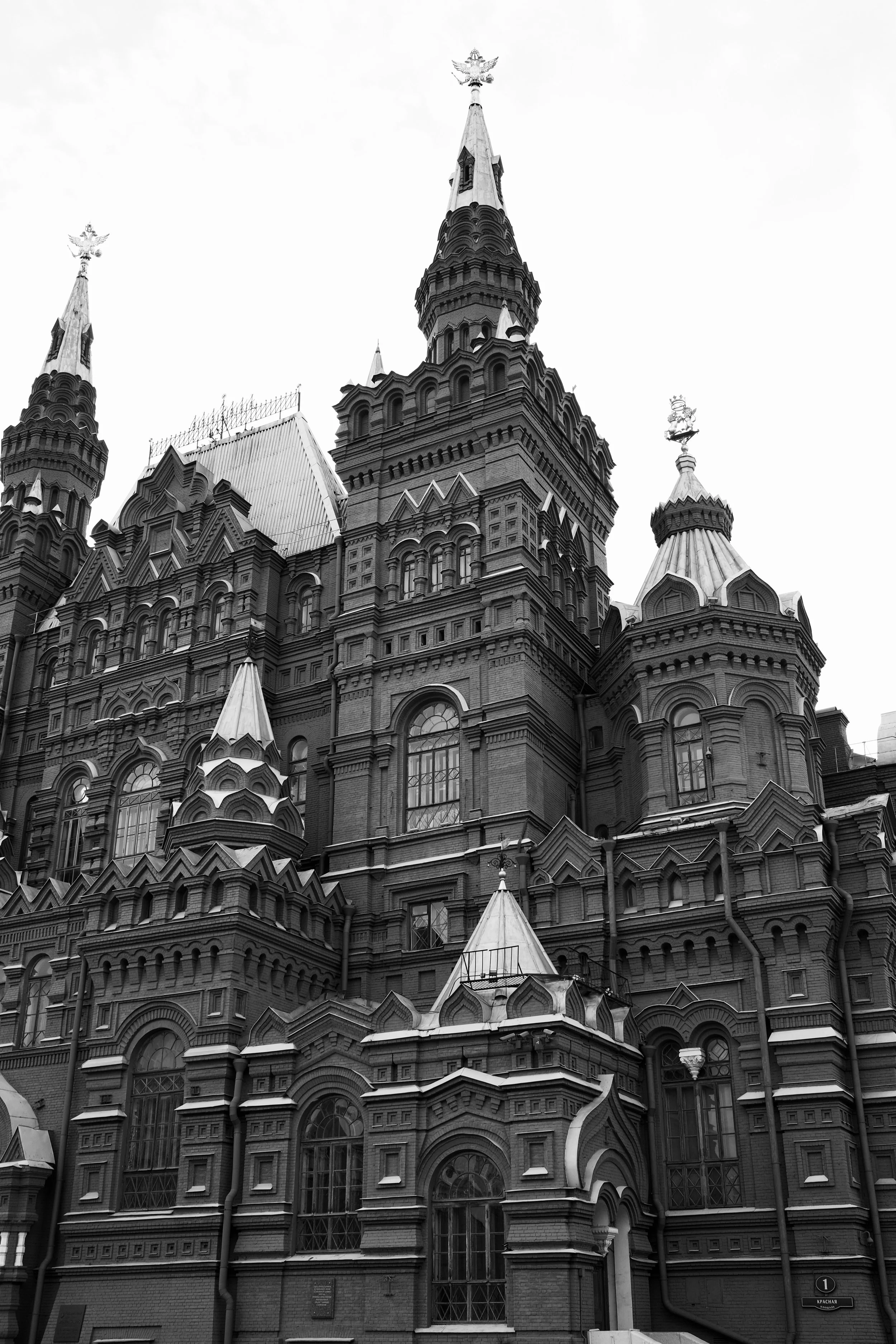 Black and white photo of a historic ornate building with multiple towers and decorative details.