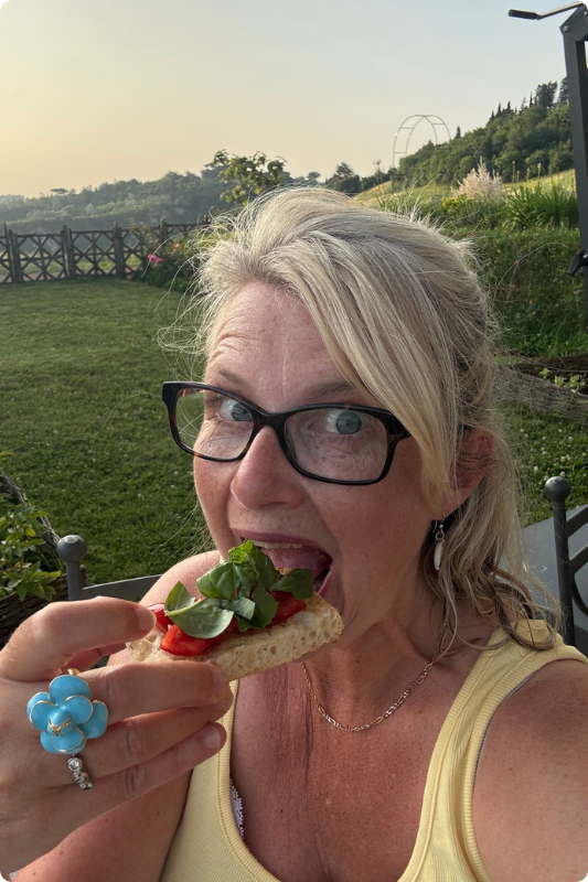 Beara enjoying fresh bruschetta with tomatoes and basil in the Tuscan countryside at sunset