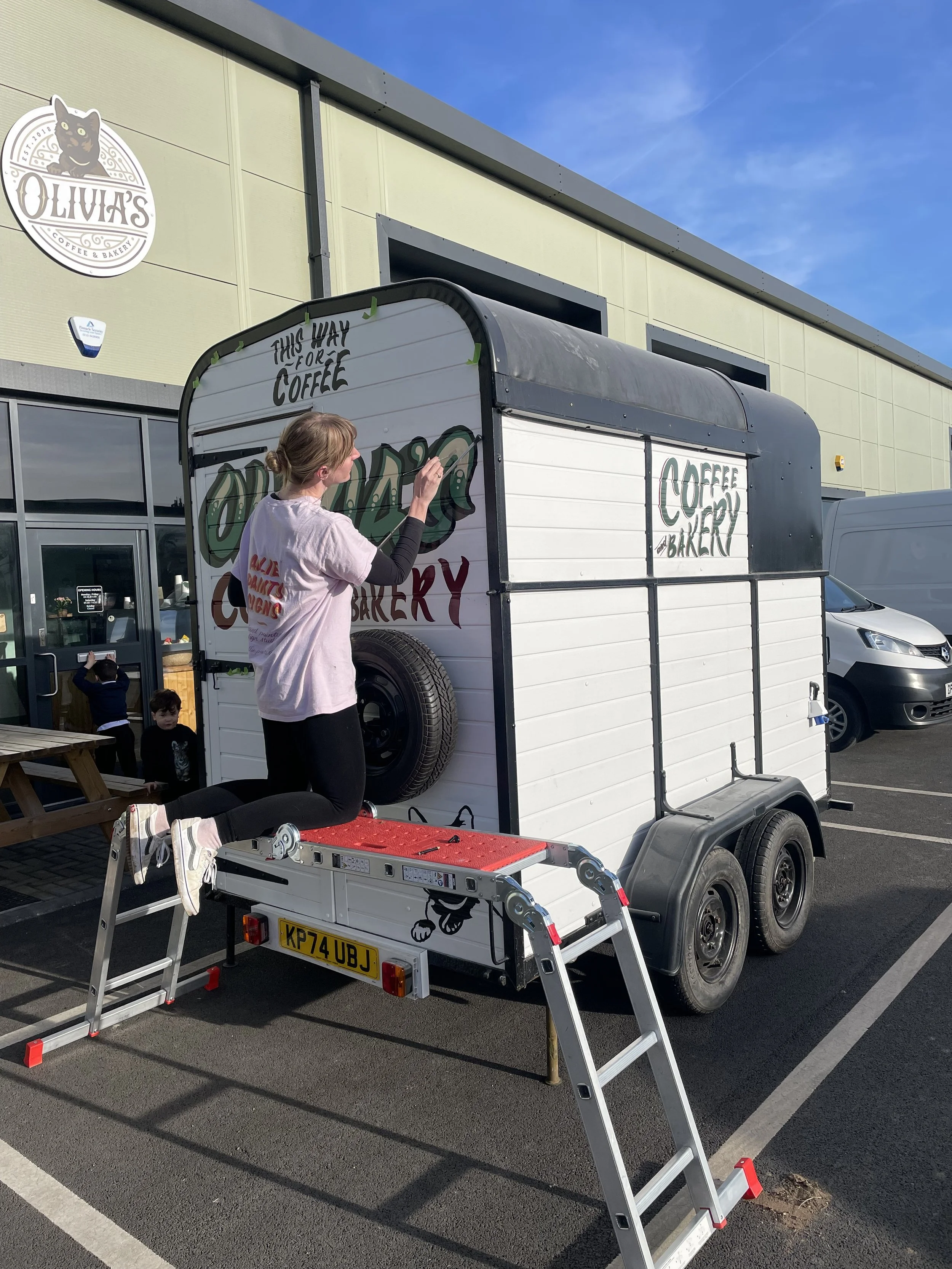 allie painting a loughborough based coffee trailer