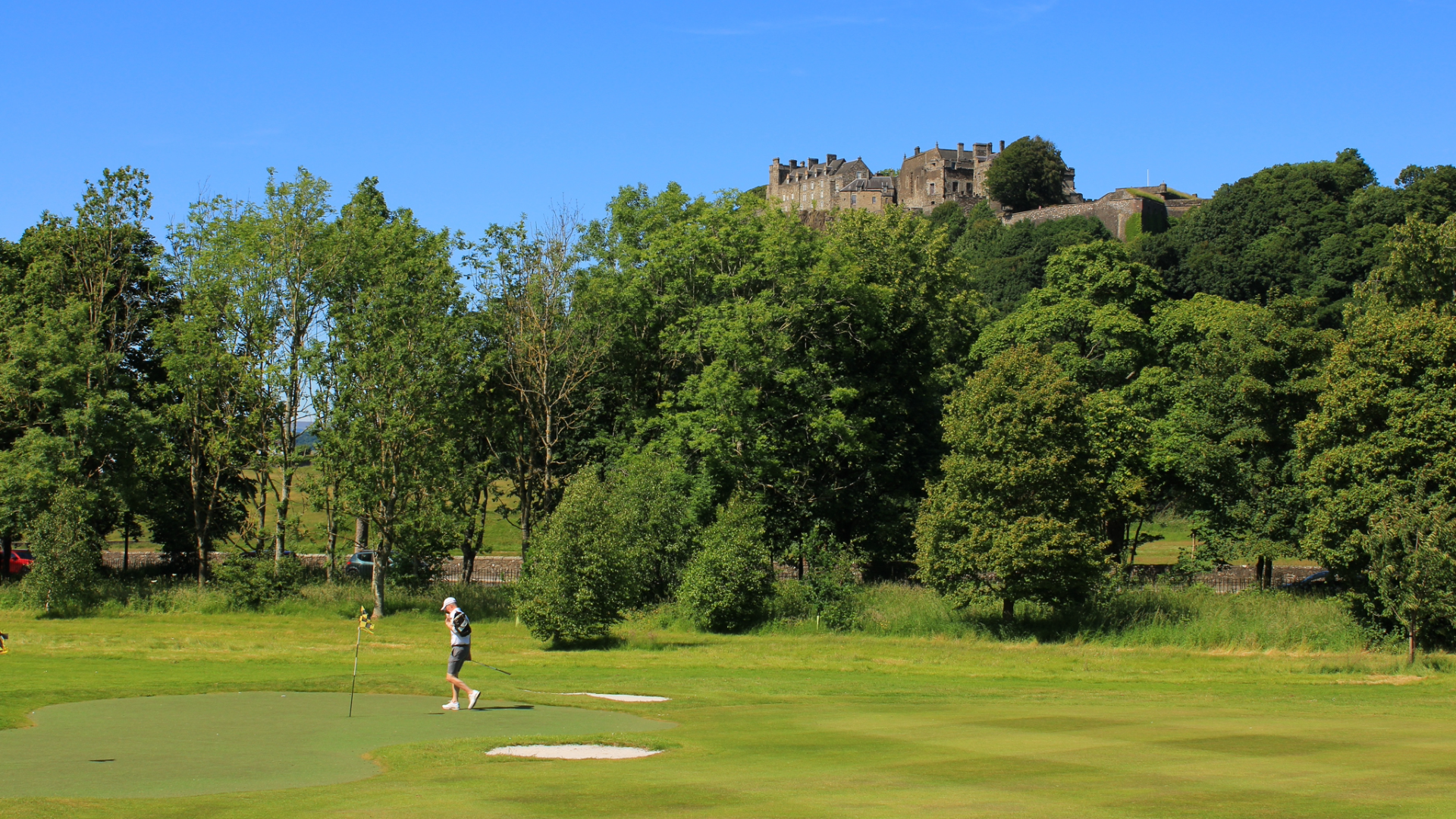 Golfer on golf tour with Stirling castle in the background