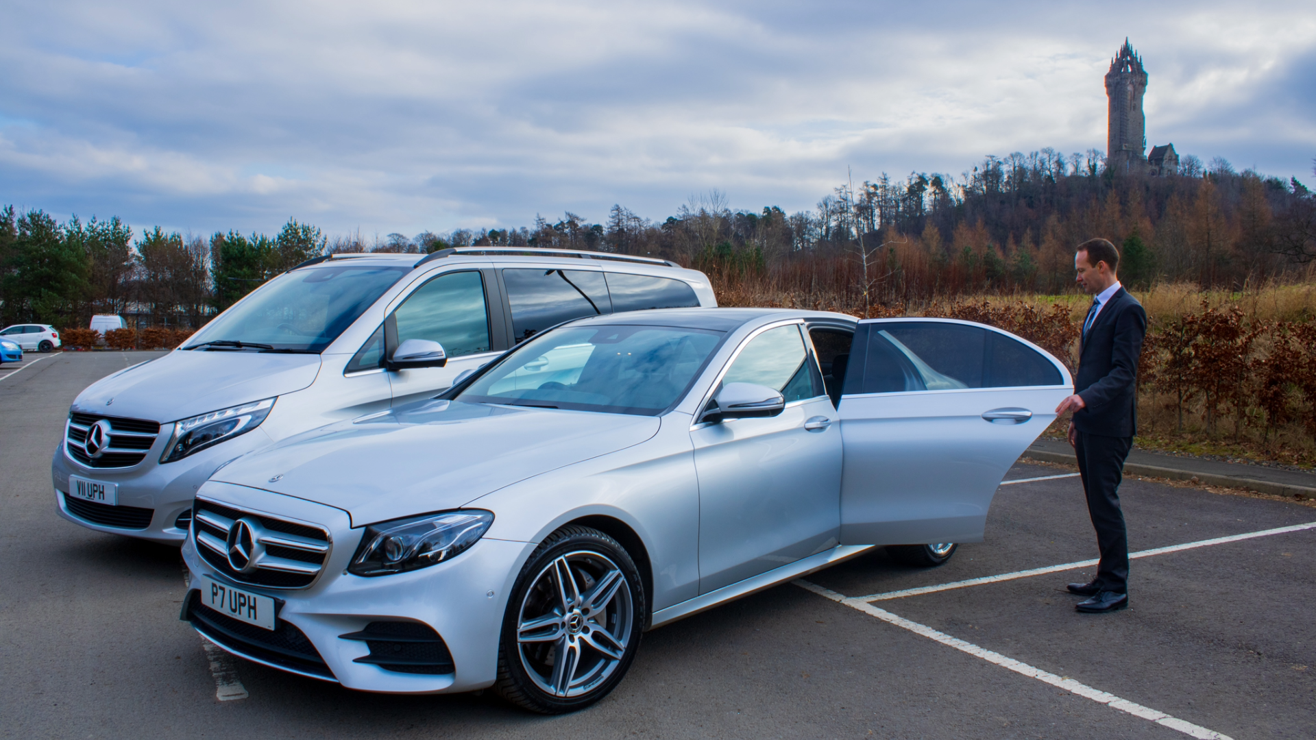 Chauffeur driver opening door for customer in Stirling