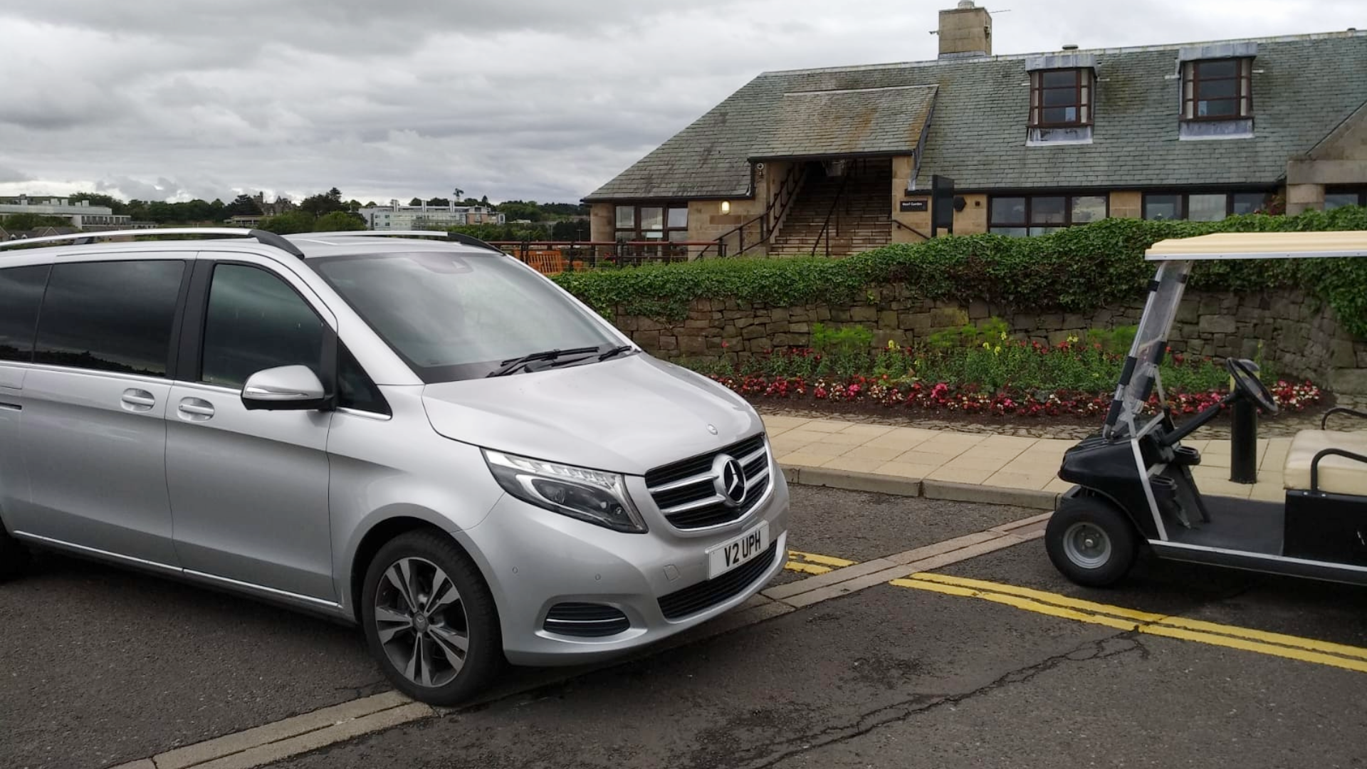 Mercedes-Benz V-Class outside golf course, parked next to golf cart