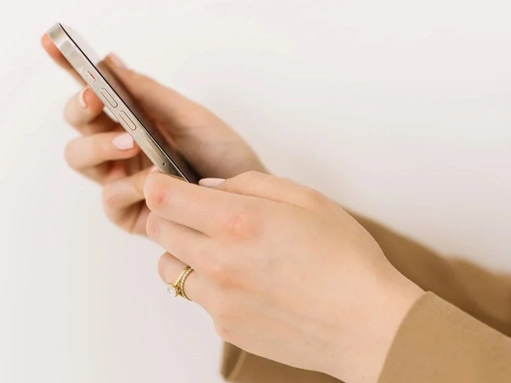 Rebecca Lee holding a phone showing a ChatGPT search for a private doctor, illustrating how AI search tools recommend consultants