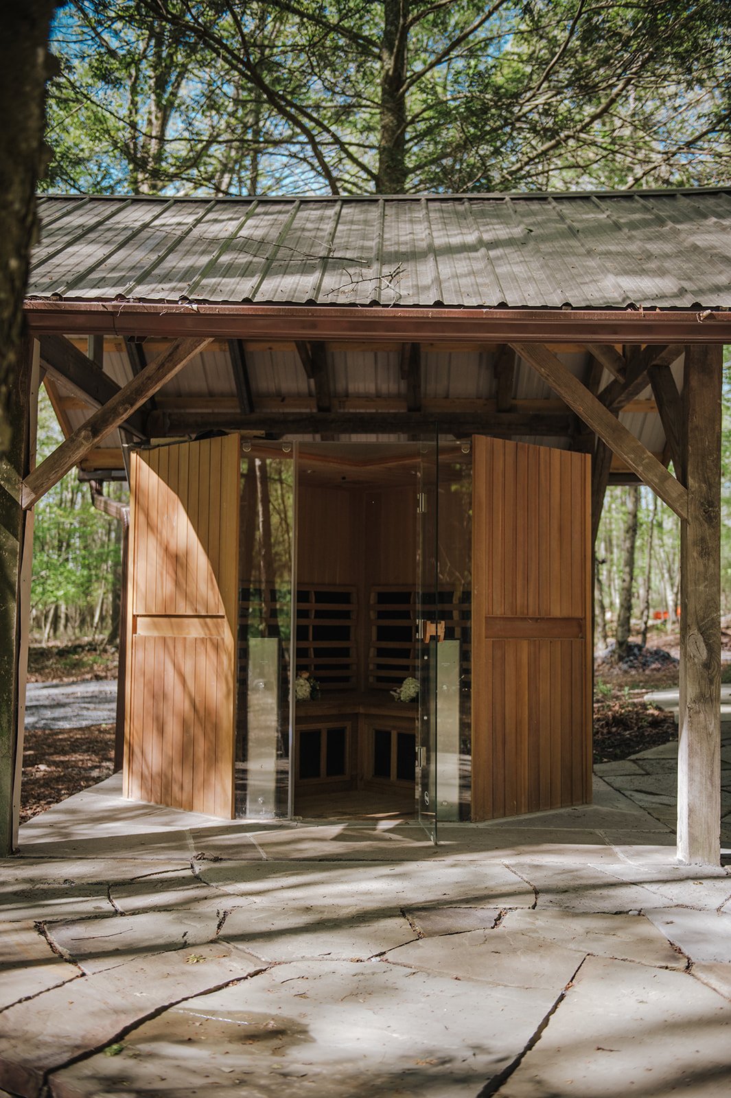 Aromatic cedar dry sauna seats 5, with views of the woods and meditation paths.