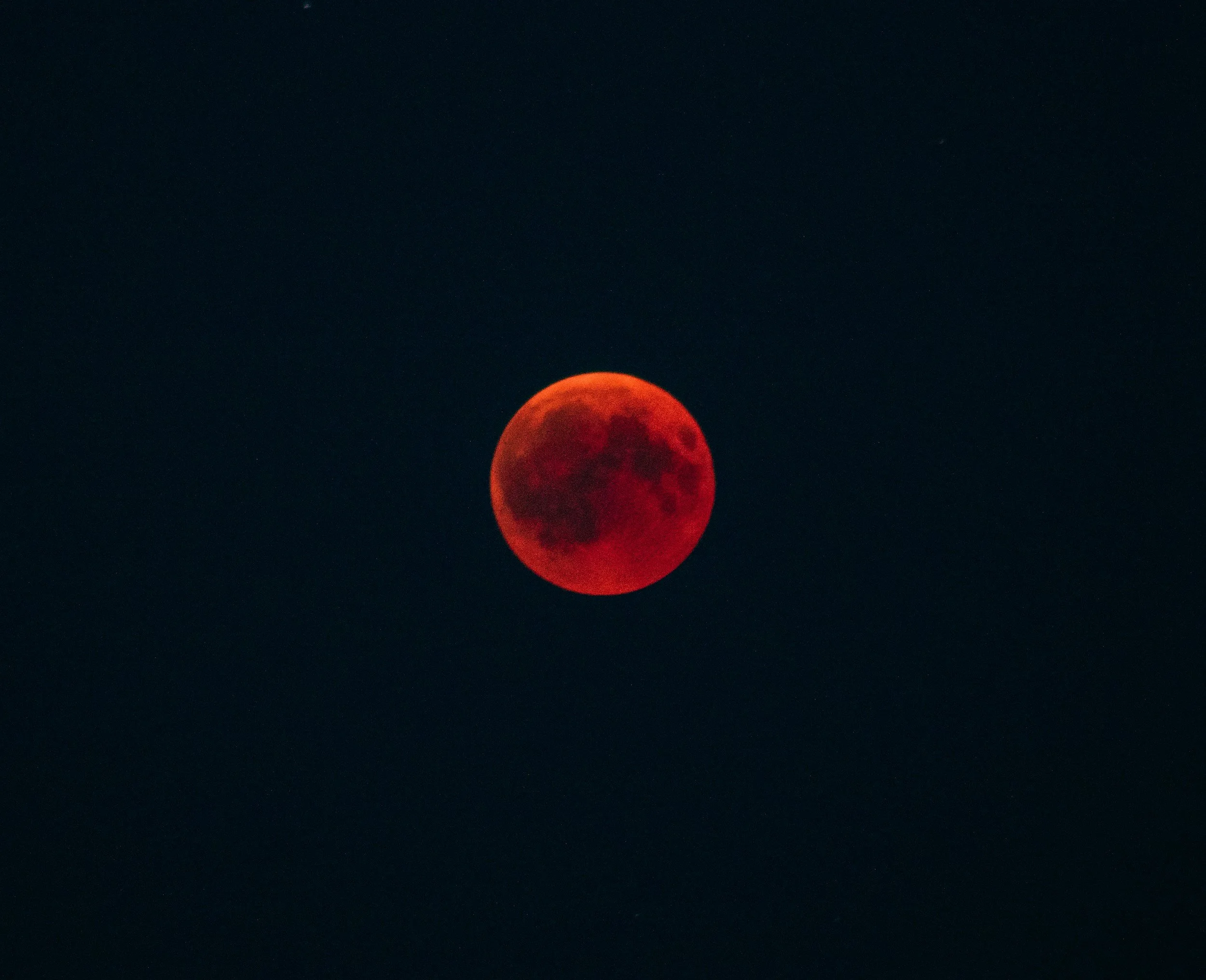 red moon in black background