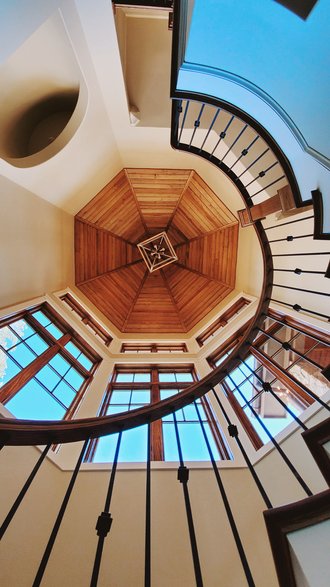 Custom curved staircase with wood ceiling and trim detail in Greenville SC