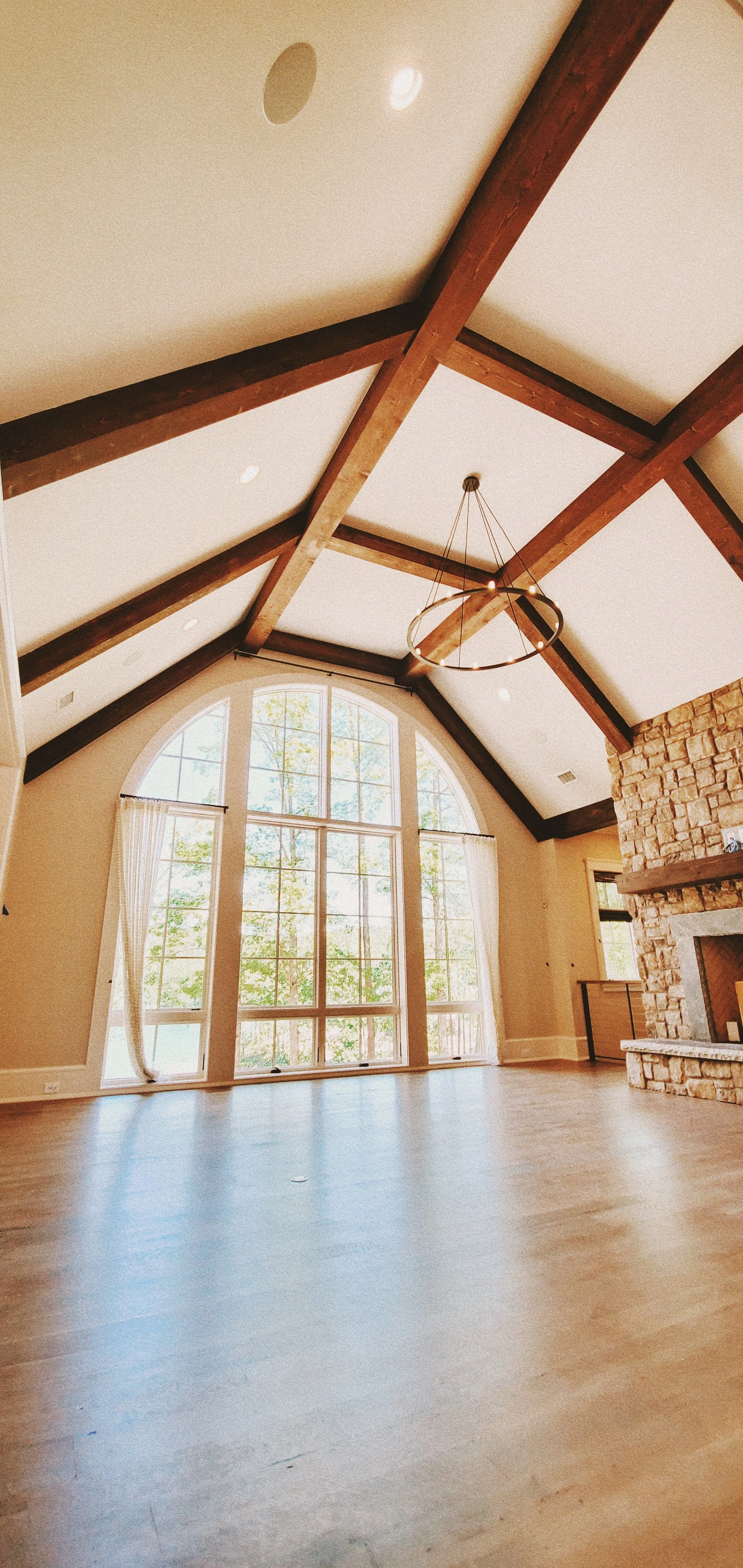 Custom vaulted ceiling with exposed wood beams and stone fireplace in Greenville SC