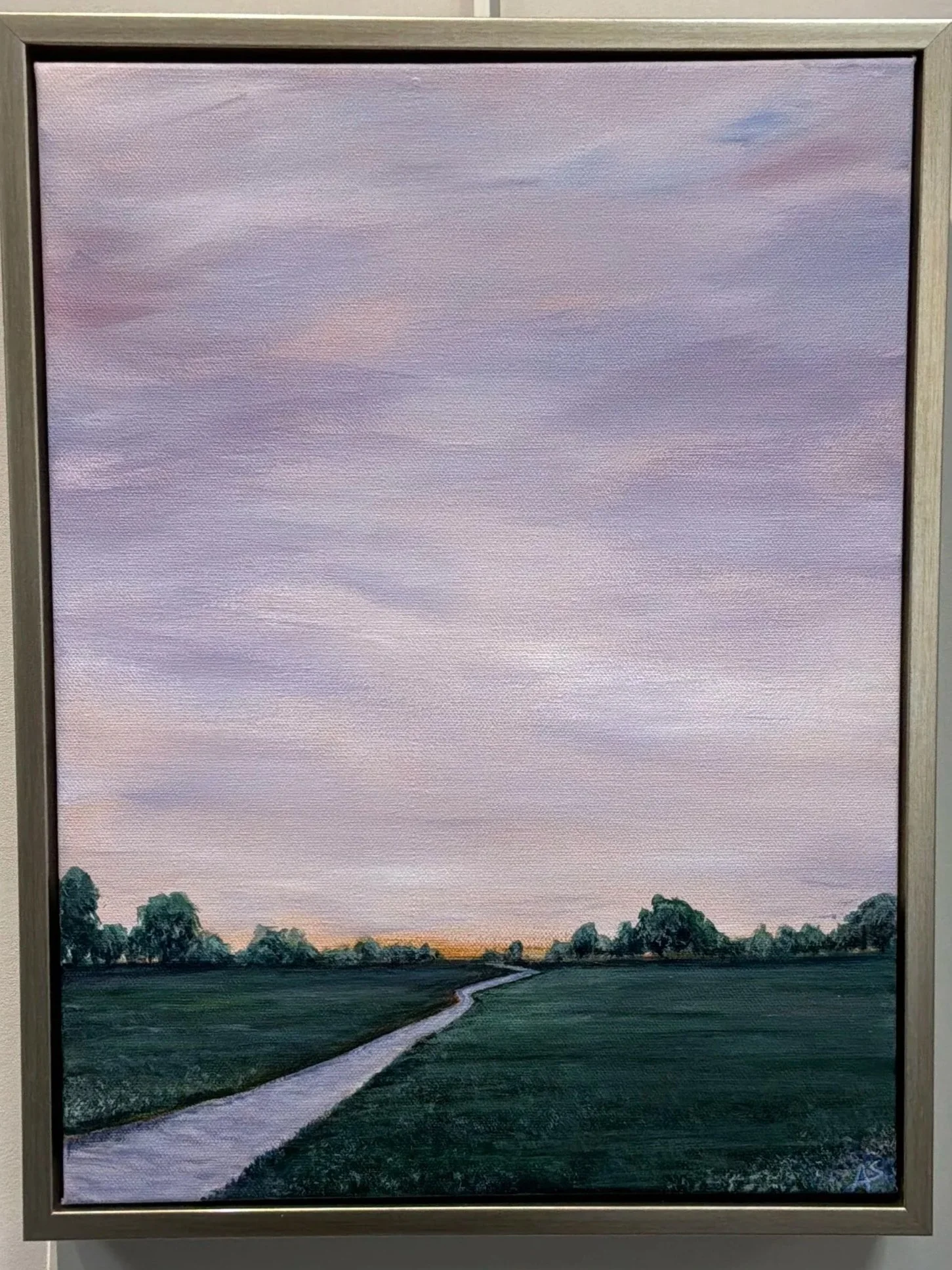 A landscape painting of a path stretching through a green field with trees along the horizon and a pink and purple cloudy sky.