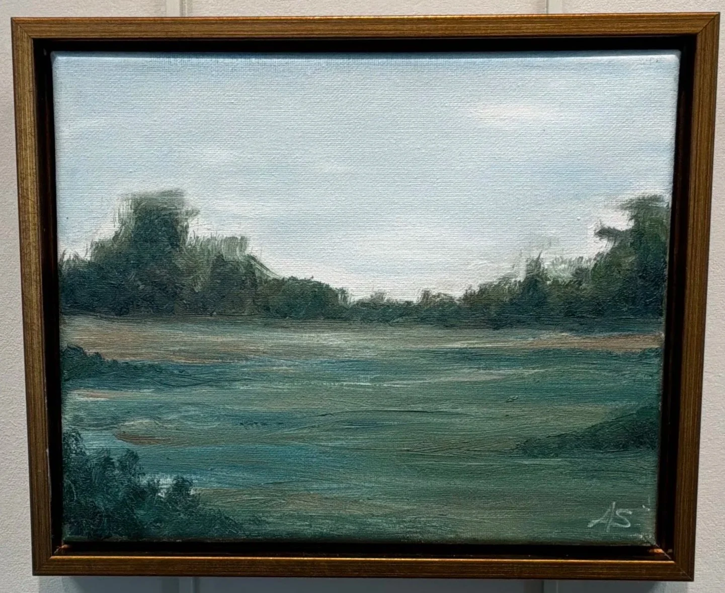 An oil painting of a tranquil landscape with grass, trees, and a cloudy sky, signed with initials in the bottom right corner.
