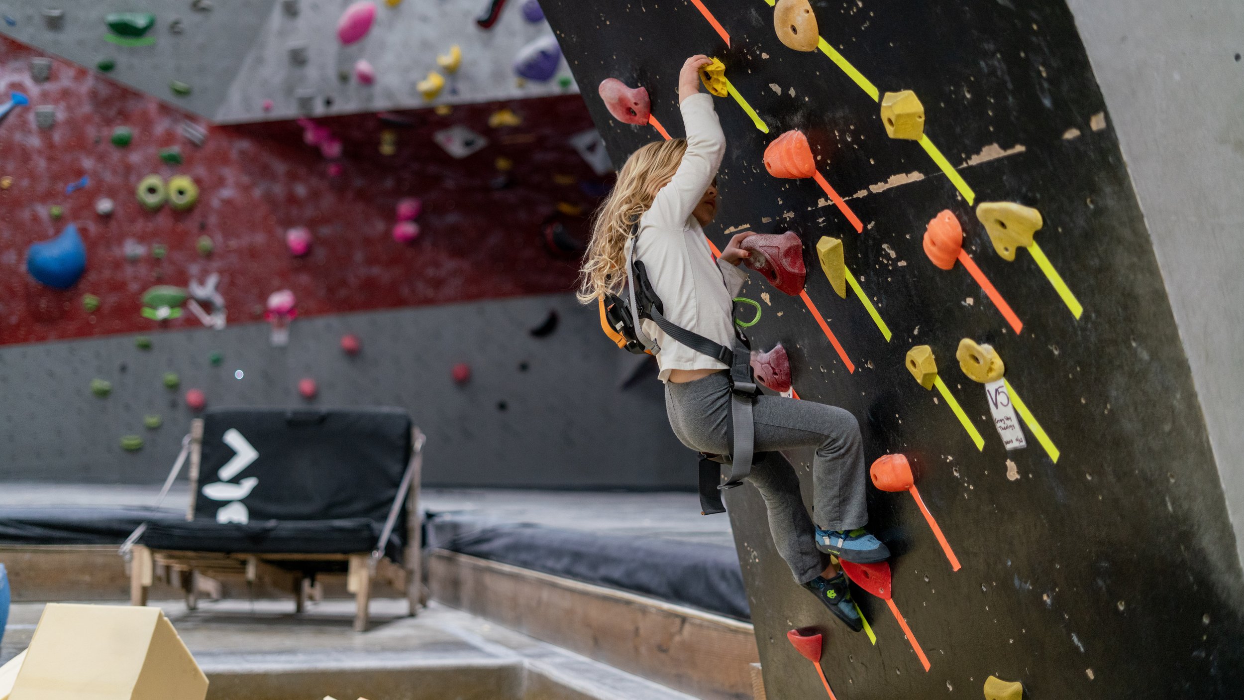 a young climber conquering her fear of heights at a climbing club