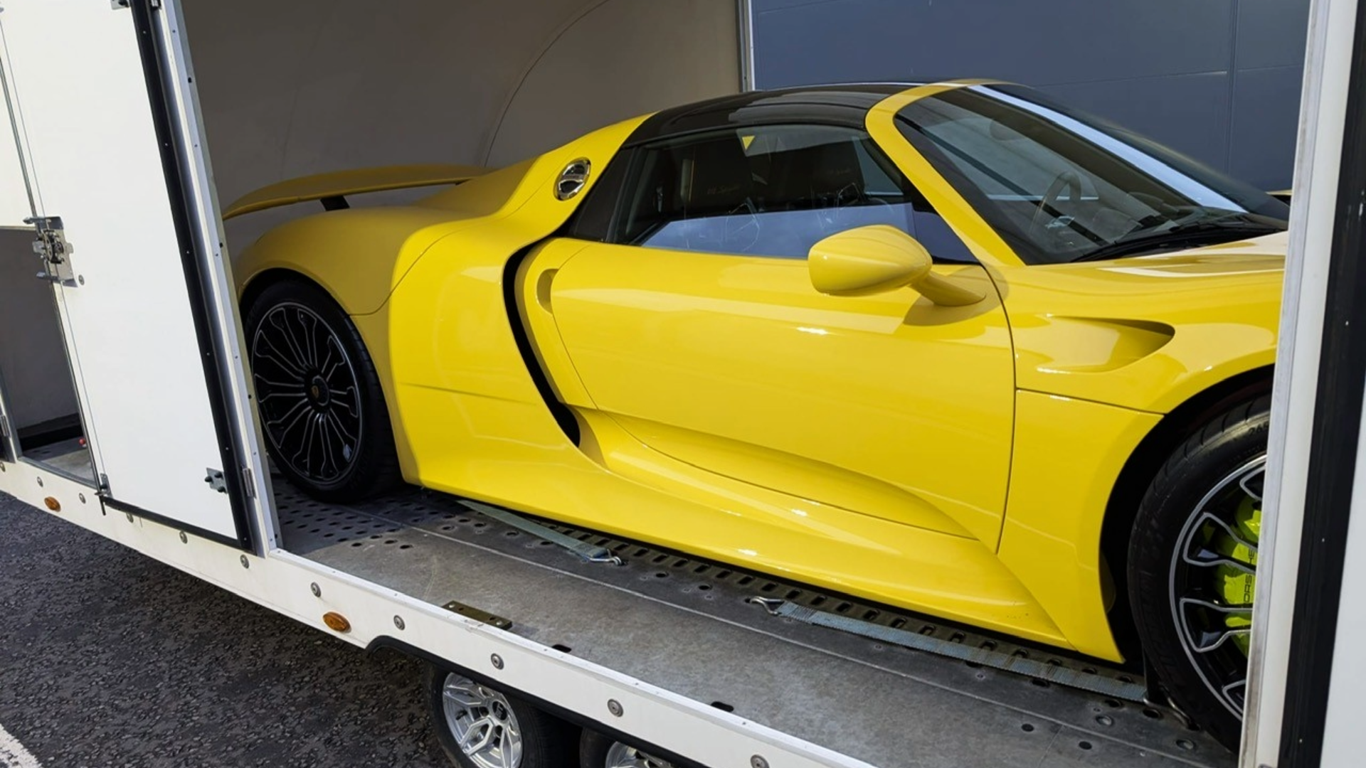 Luxury vehicle in enclosed trailer