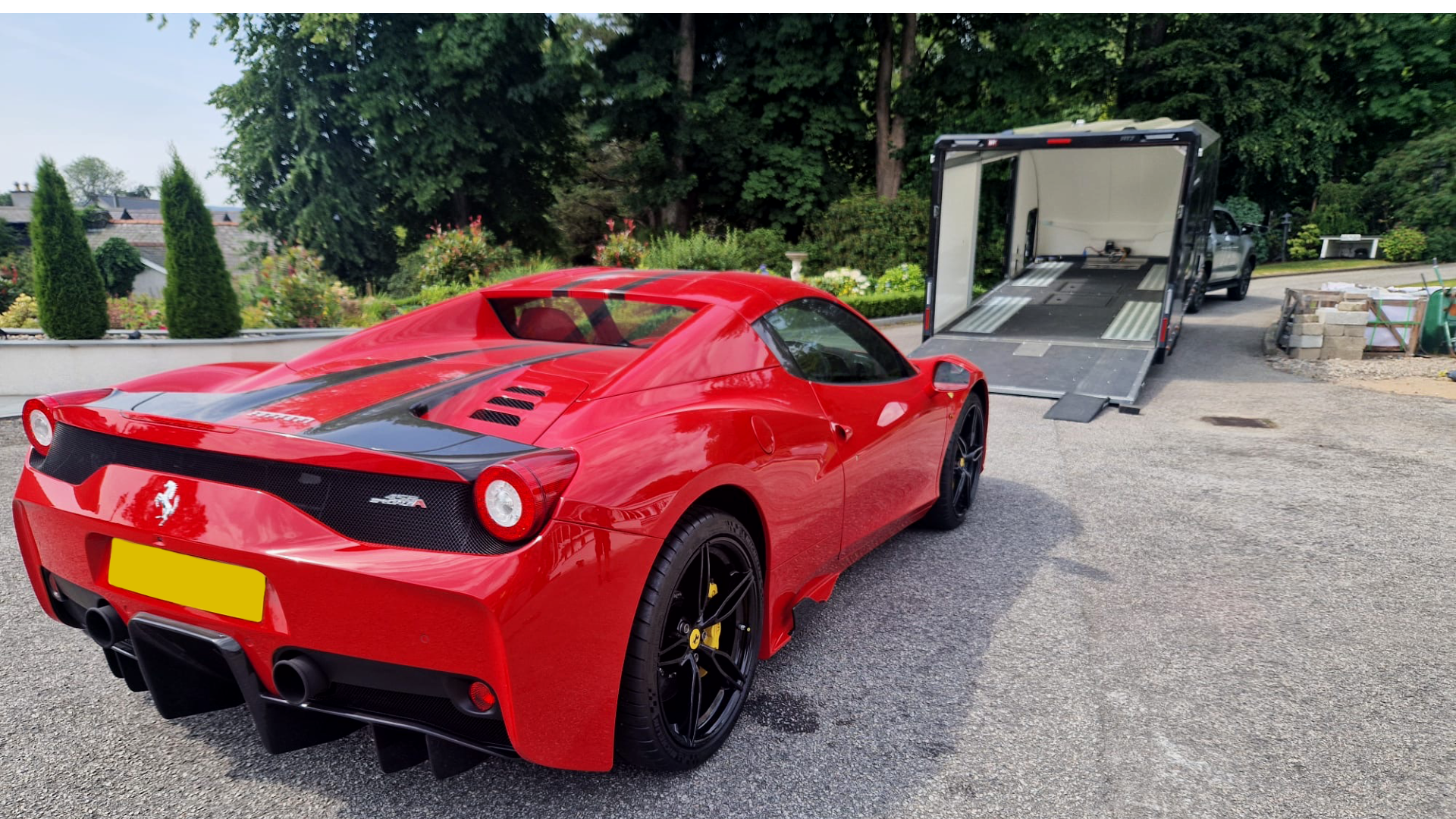 Ferrari being loaded on to a enclosed trailer