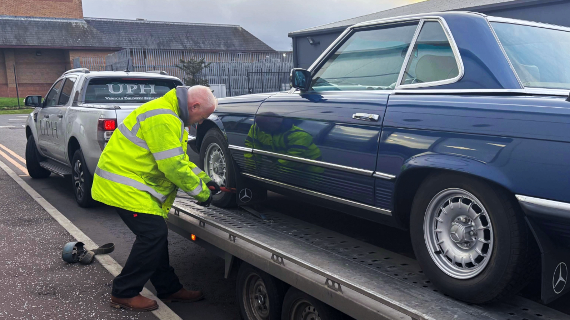 Classic car being secured to single vehicle trailer