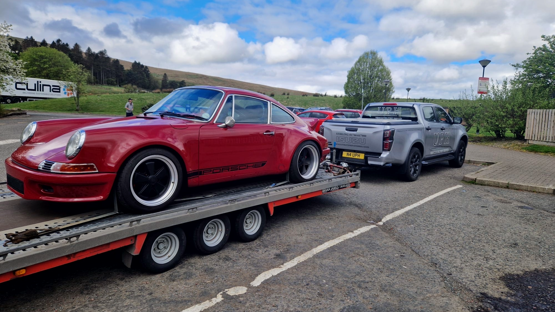 Red Porsche on open car transporter