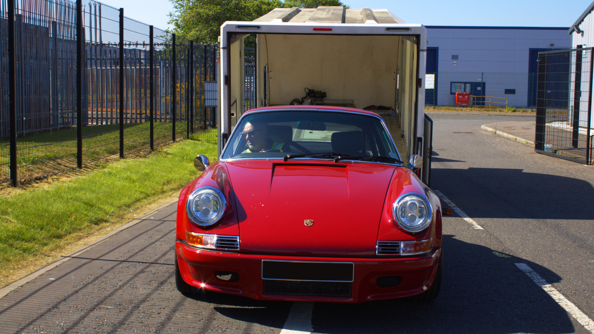 Luxury car being loaded onto covered trailer by VDS team