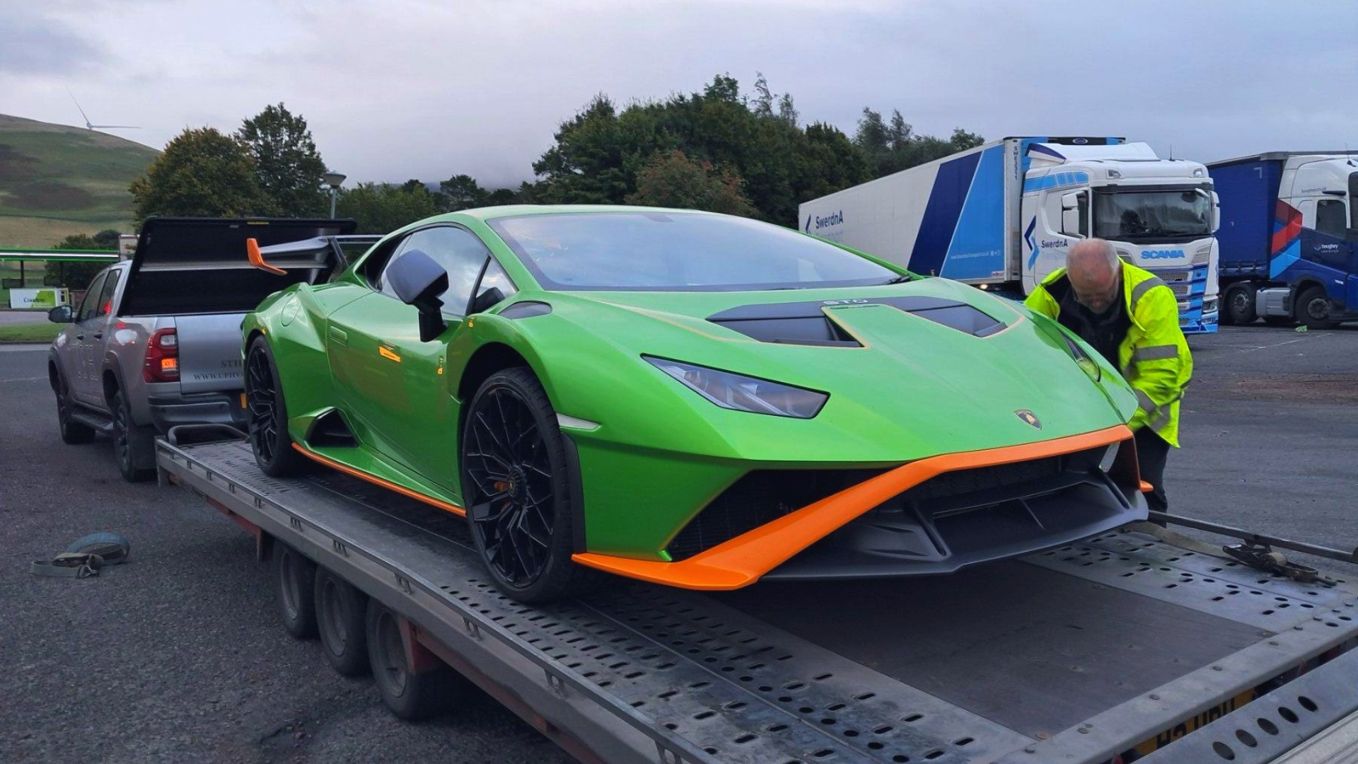 Lamborghini being transported on open single vehicle trailer