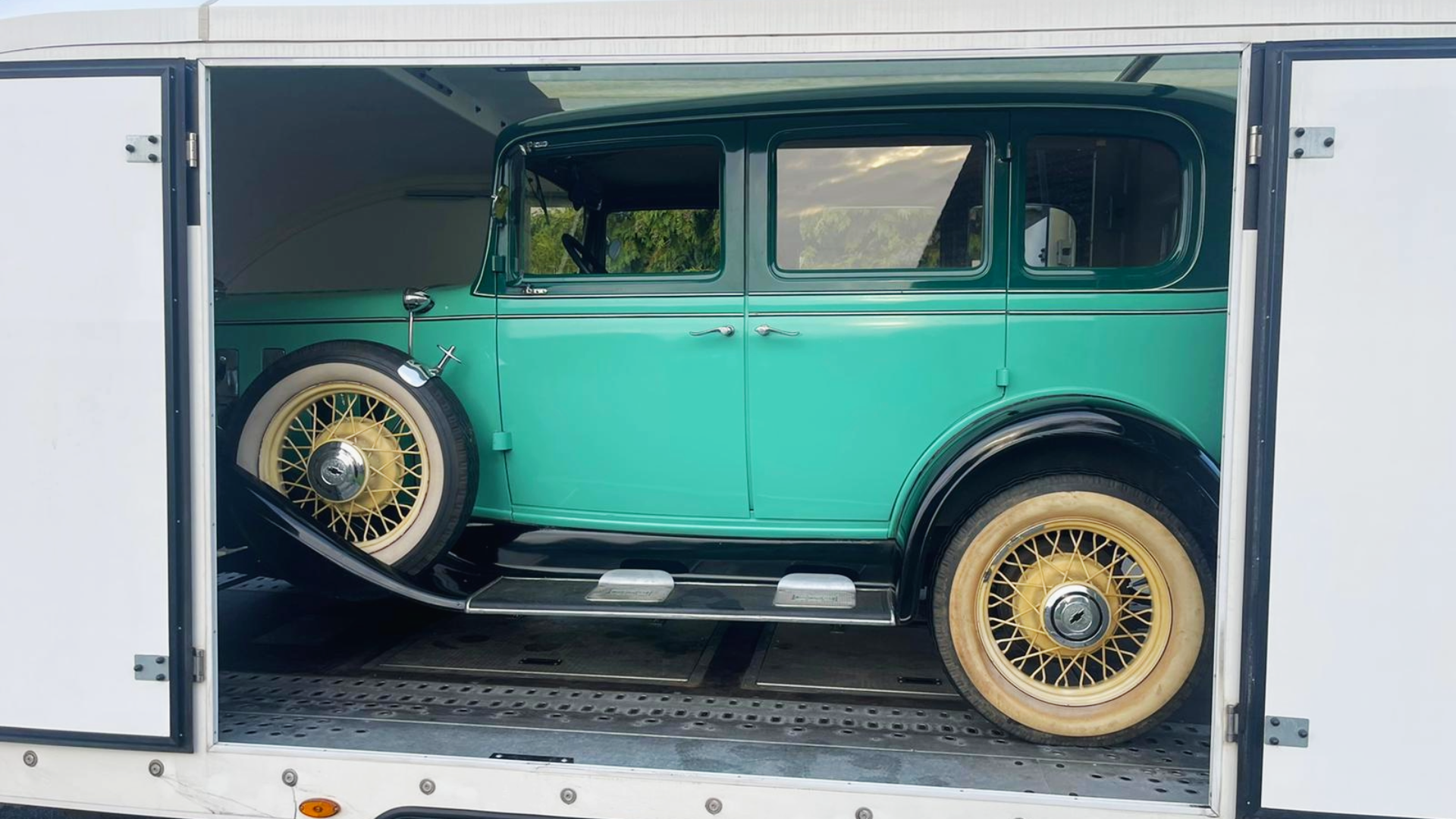 Classic vintage vehicle loaded on an enclosed trailer