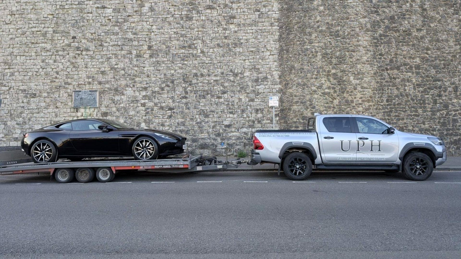 Porsche attached to open trailer - luxury vehicle delivery