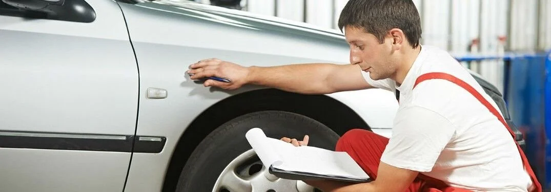 Mechanic-inspecting-the-body-panel-of-a-vehicle_A_b.jpg