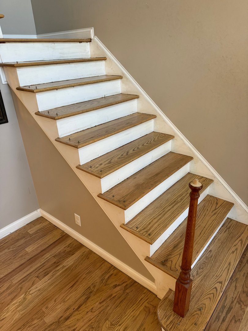 Red oak wood with a duraseal weathered oak stain with matching stairs. Floor installation in a private residence.