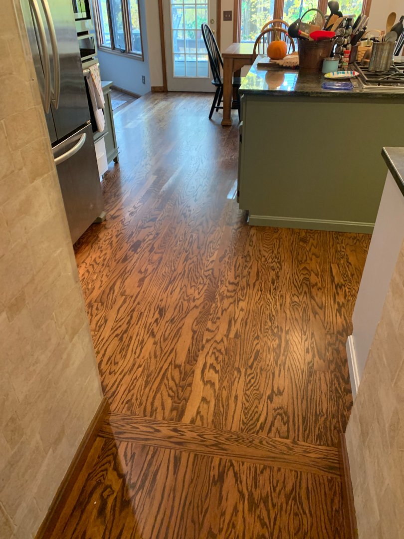 Red oak wood with a golden brown stain, floor restoration