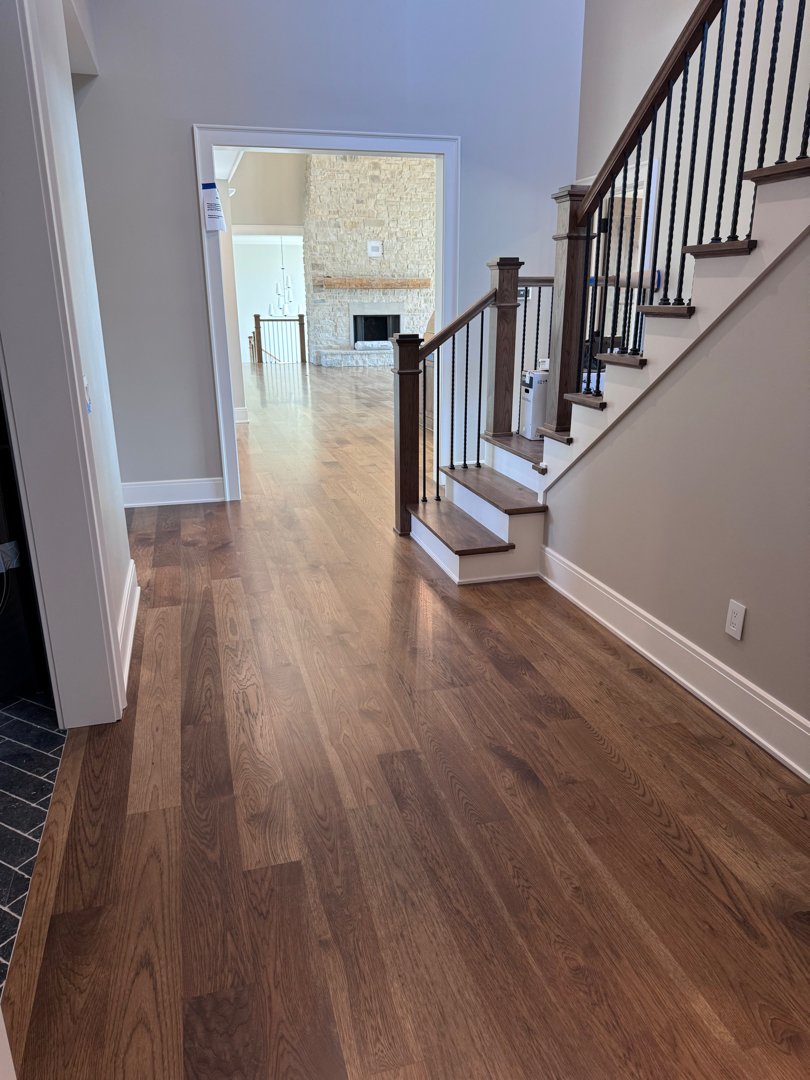 Floor and stair installation with matching railing in a private residence.