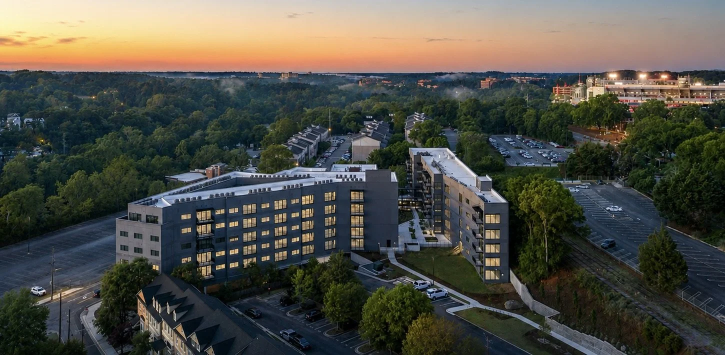 An aerial view of the 1785 Residence Club a collection of 18 luxury condominiums in Athens, GA close to Sanford Stadium which is lit up on the right